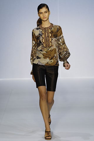 brown silk blouse with black shorts