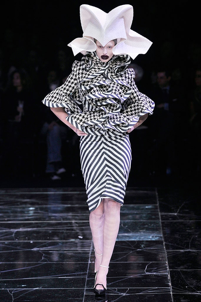 fitted black and white ruffled dress with structured hat