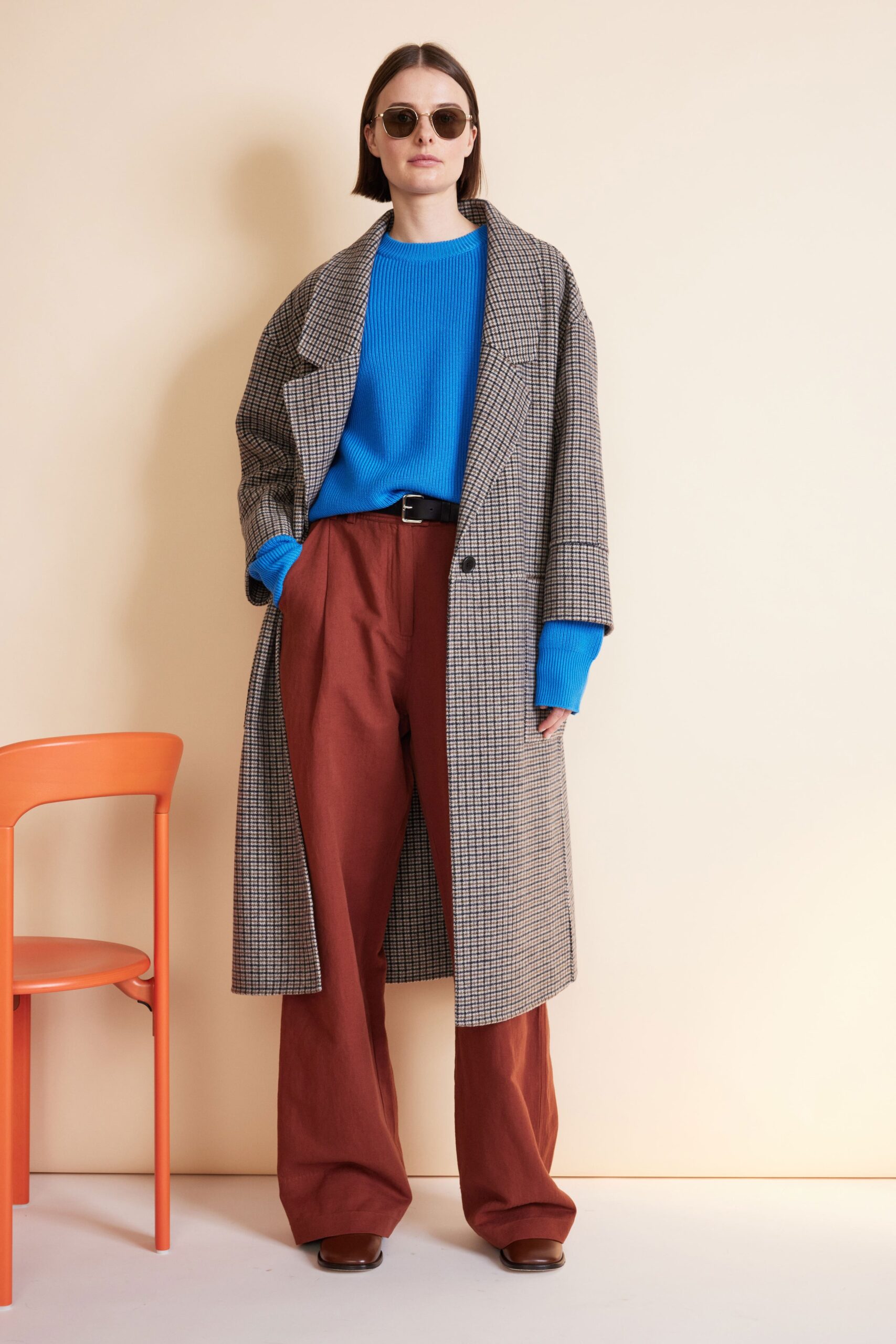 gray coat blue sweater brown pants