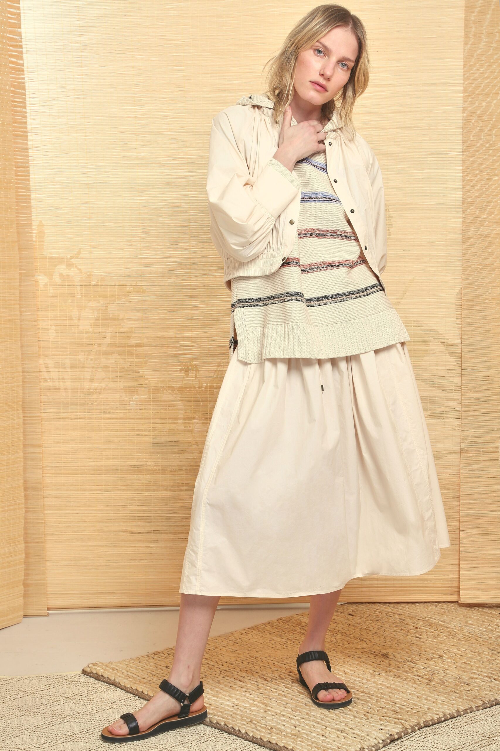 beige jacket with striped sweater