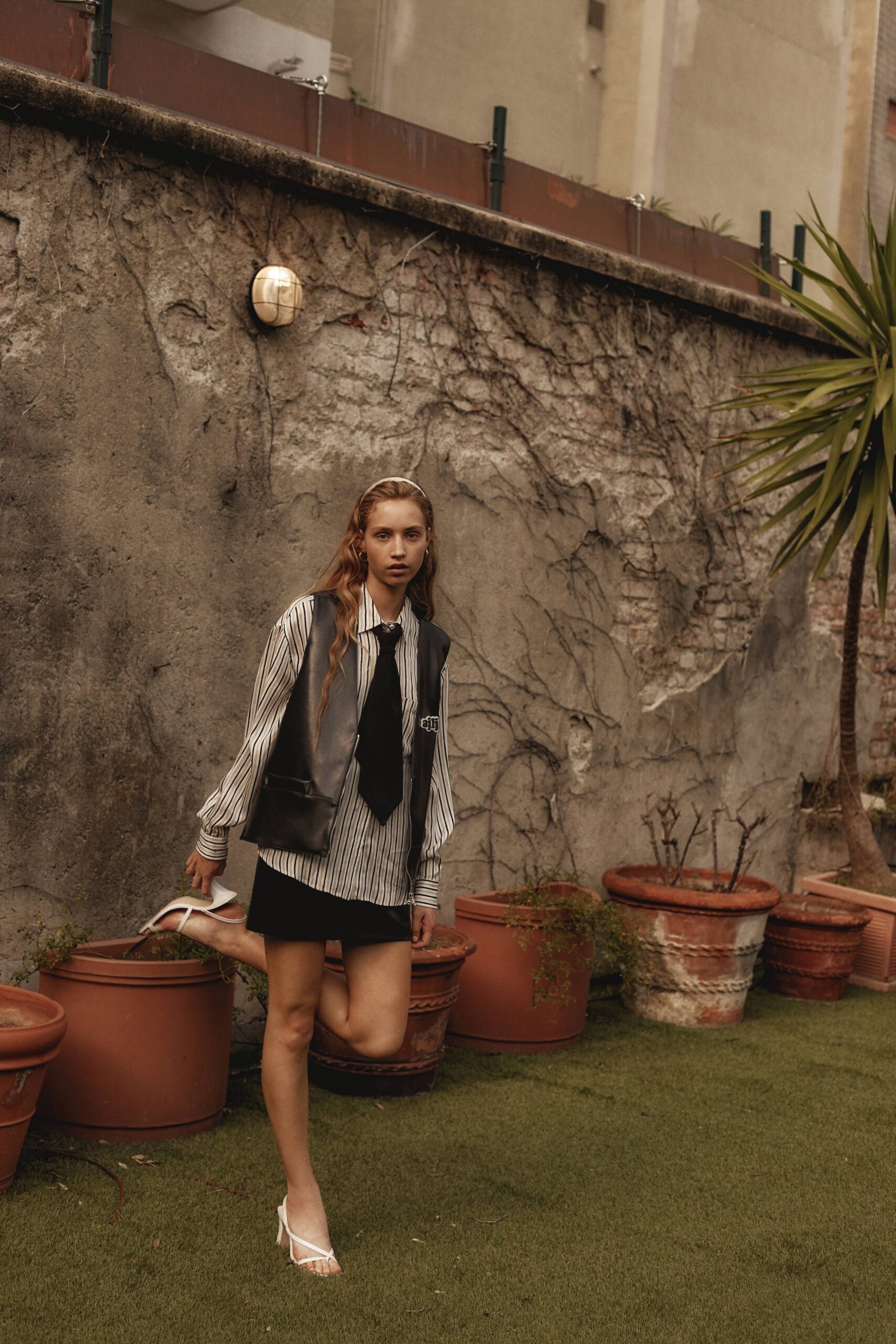 black leather vest with striped shirt