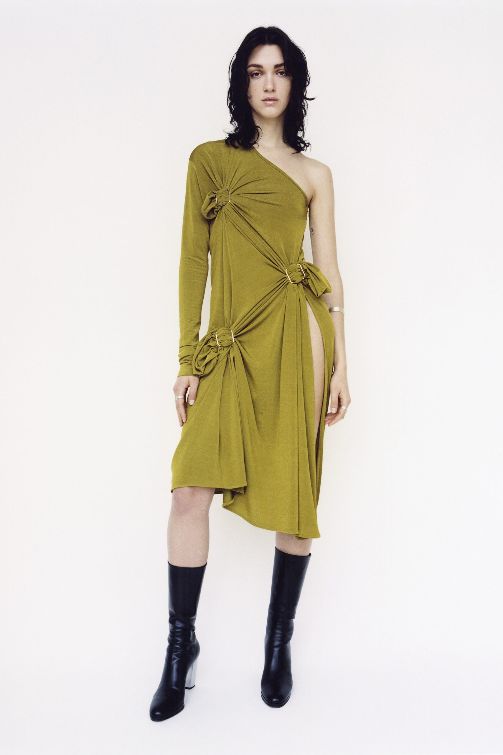 green asymmetric draped dress with black boots