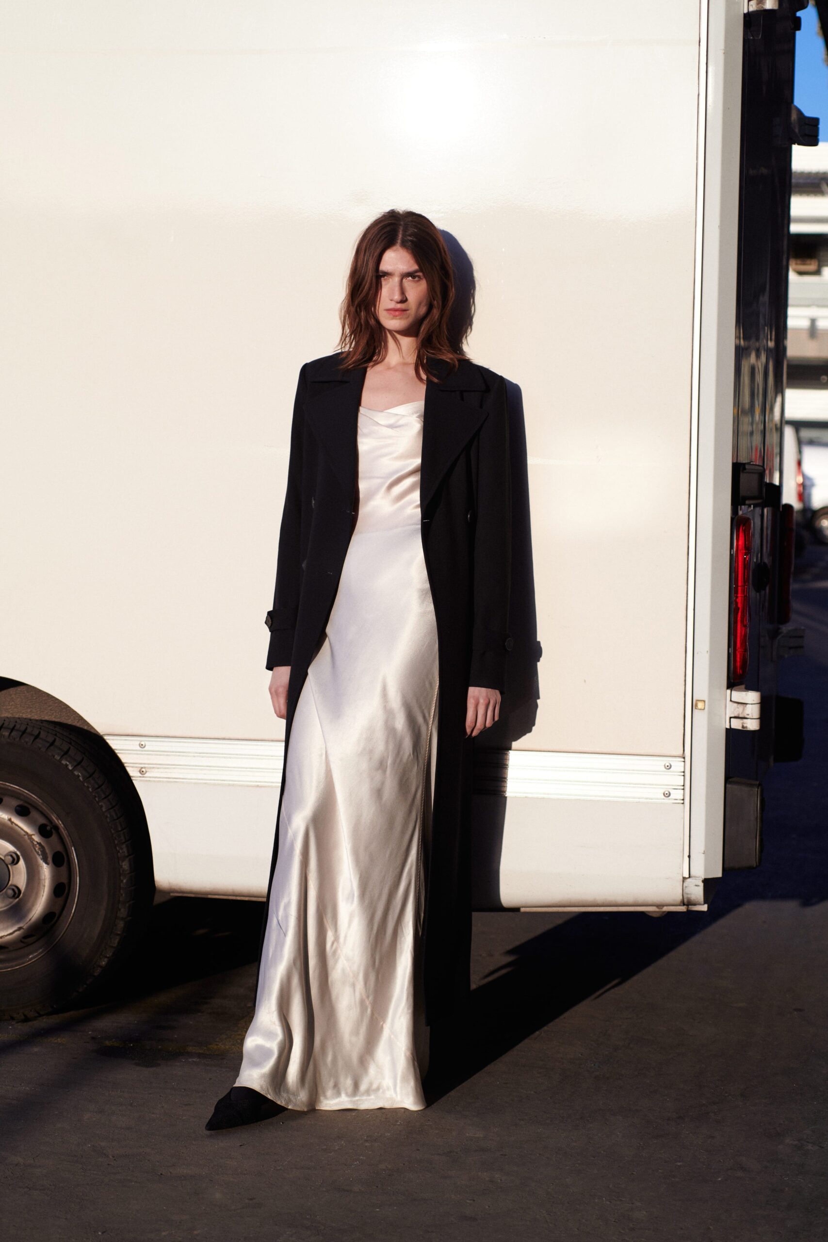 black wool coat and white silk gown