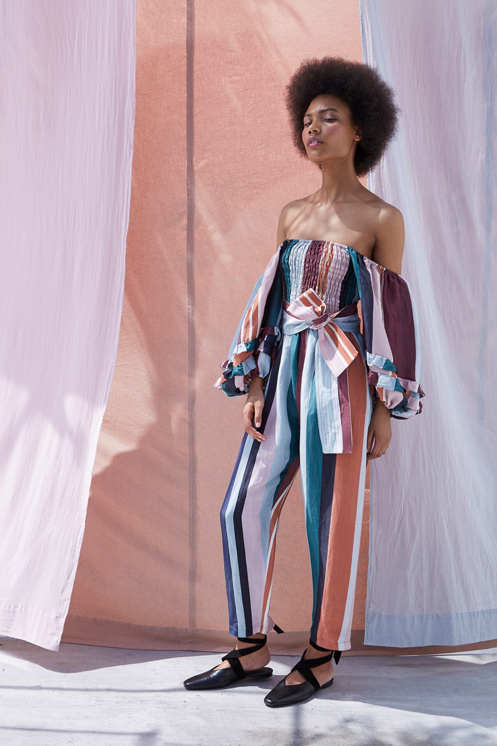 multi-colored off-shoulder top and striped pants