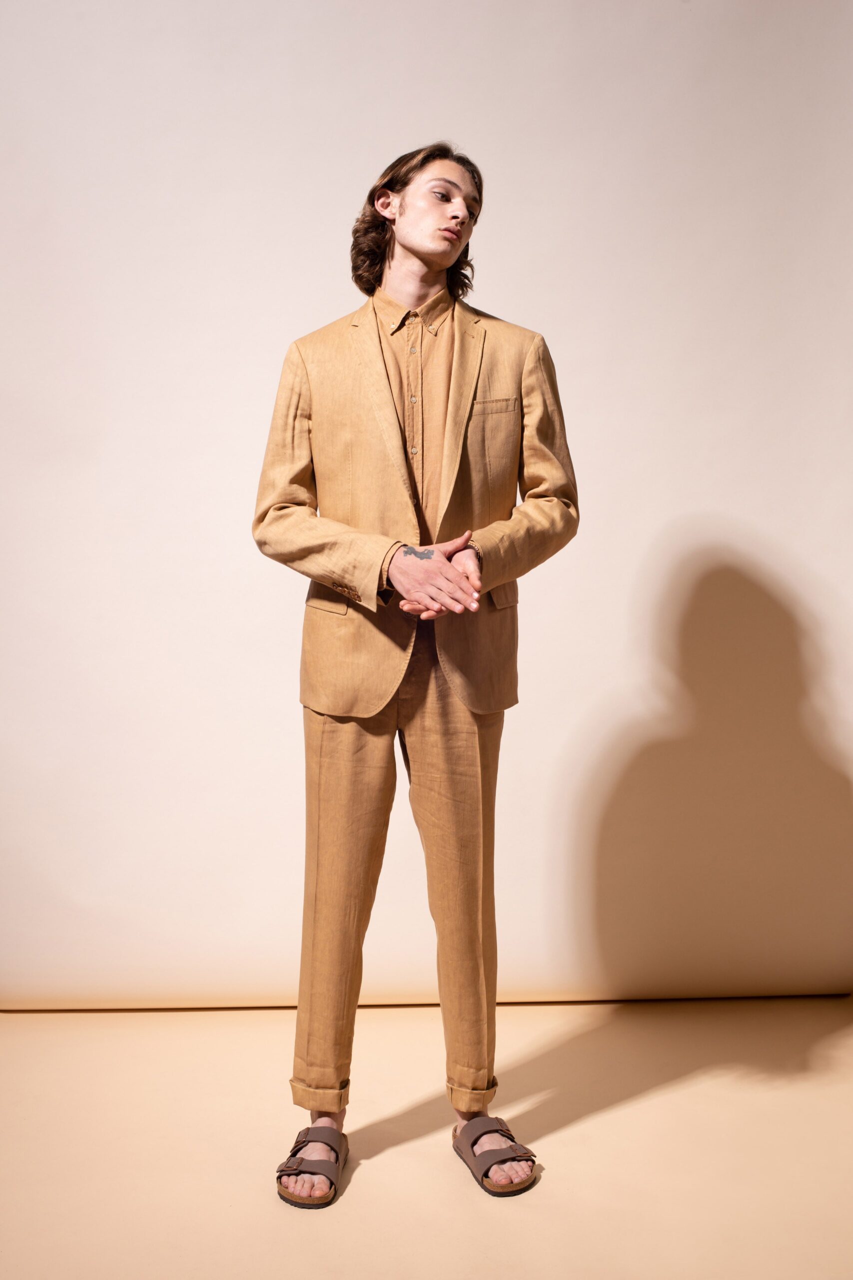 beige tailored suit with brown shoes
