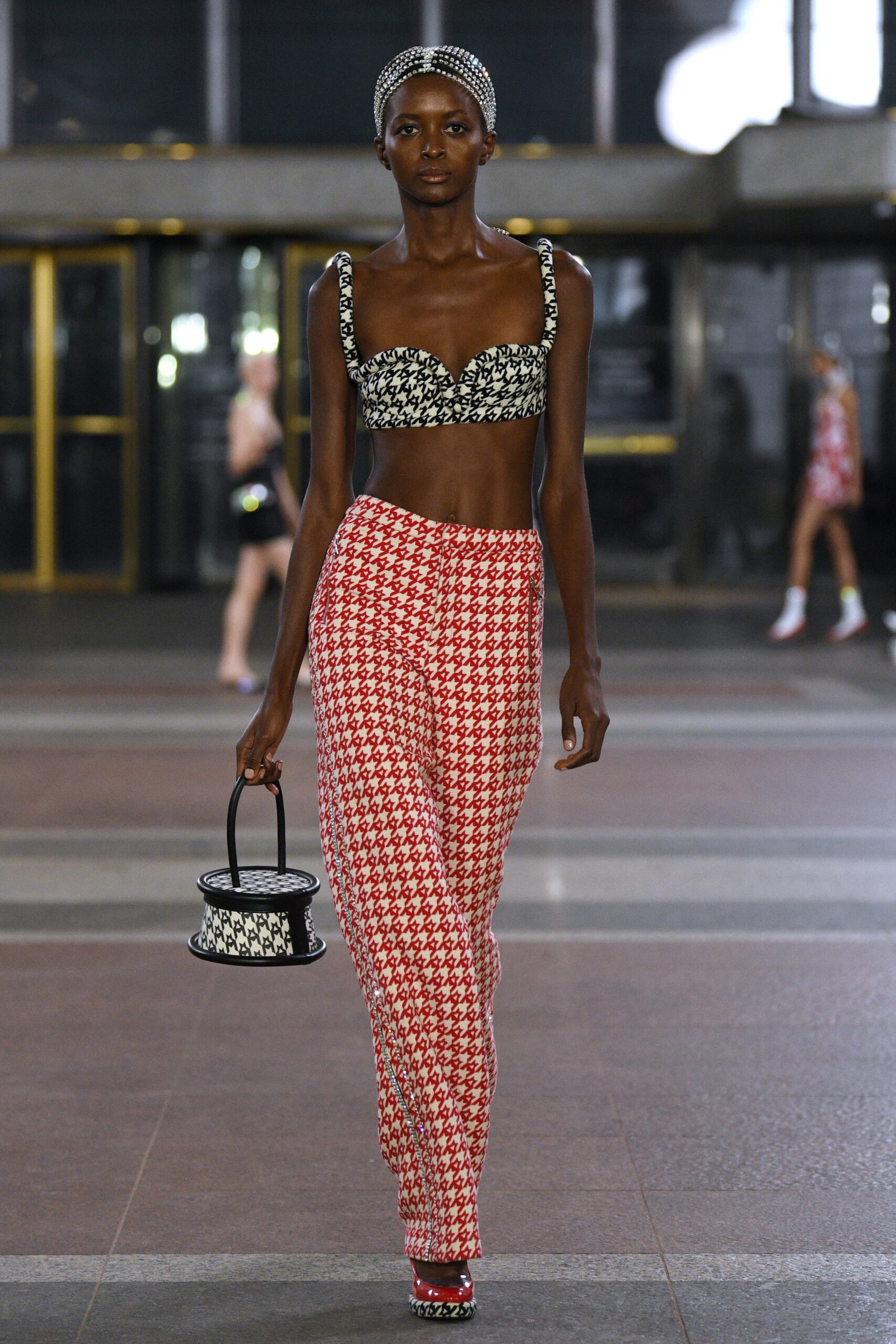 black and white printed bustier with red pants