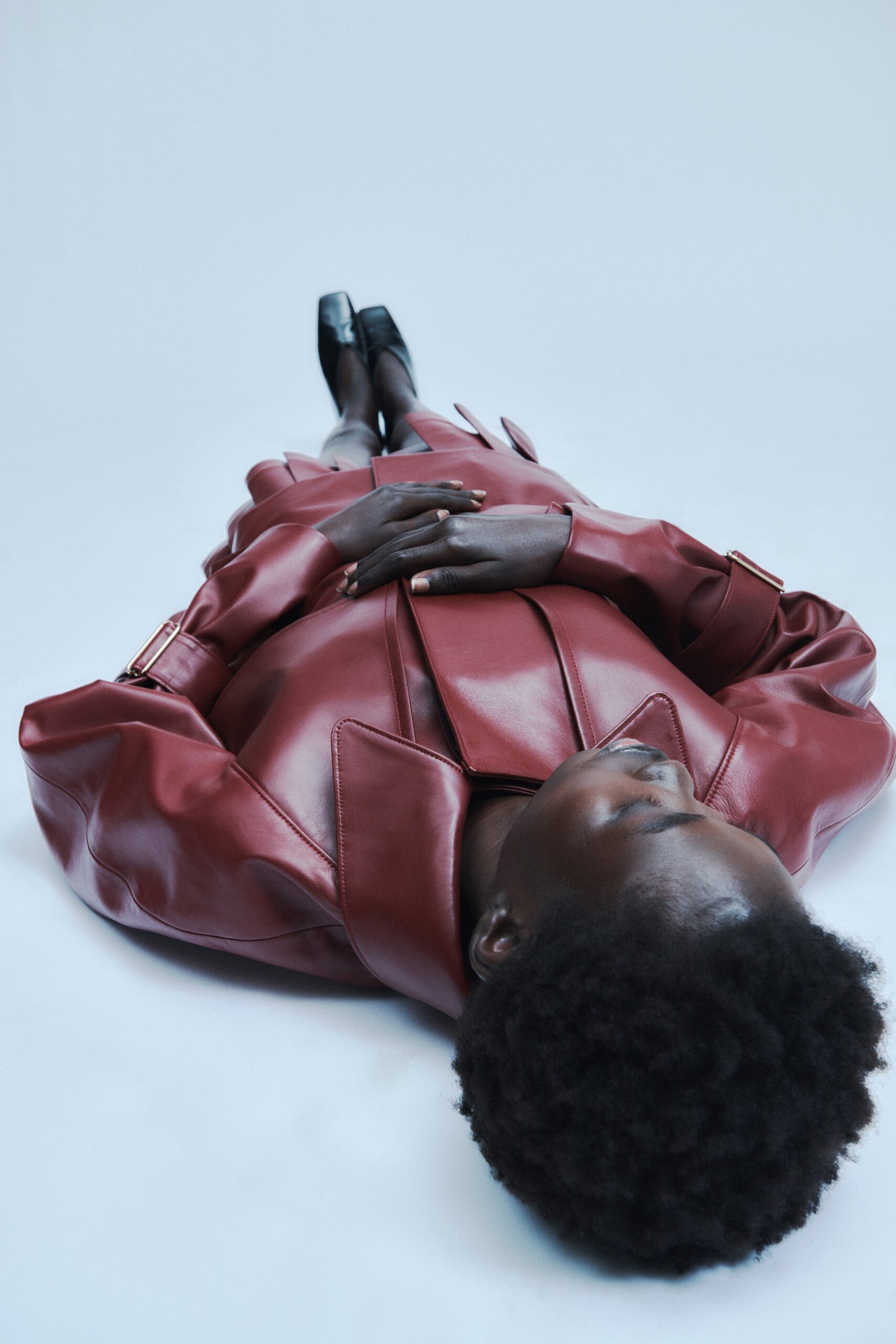 red leather long-sleeve collared oversized belted pleated coat