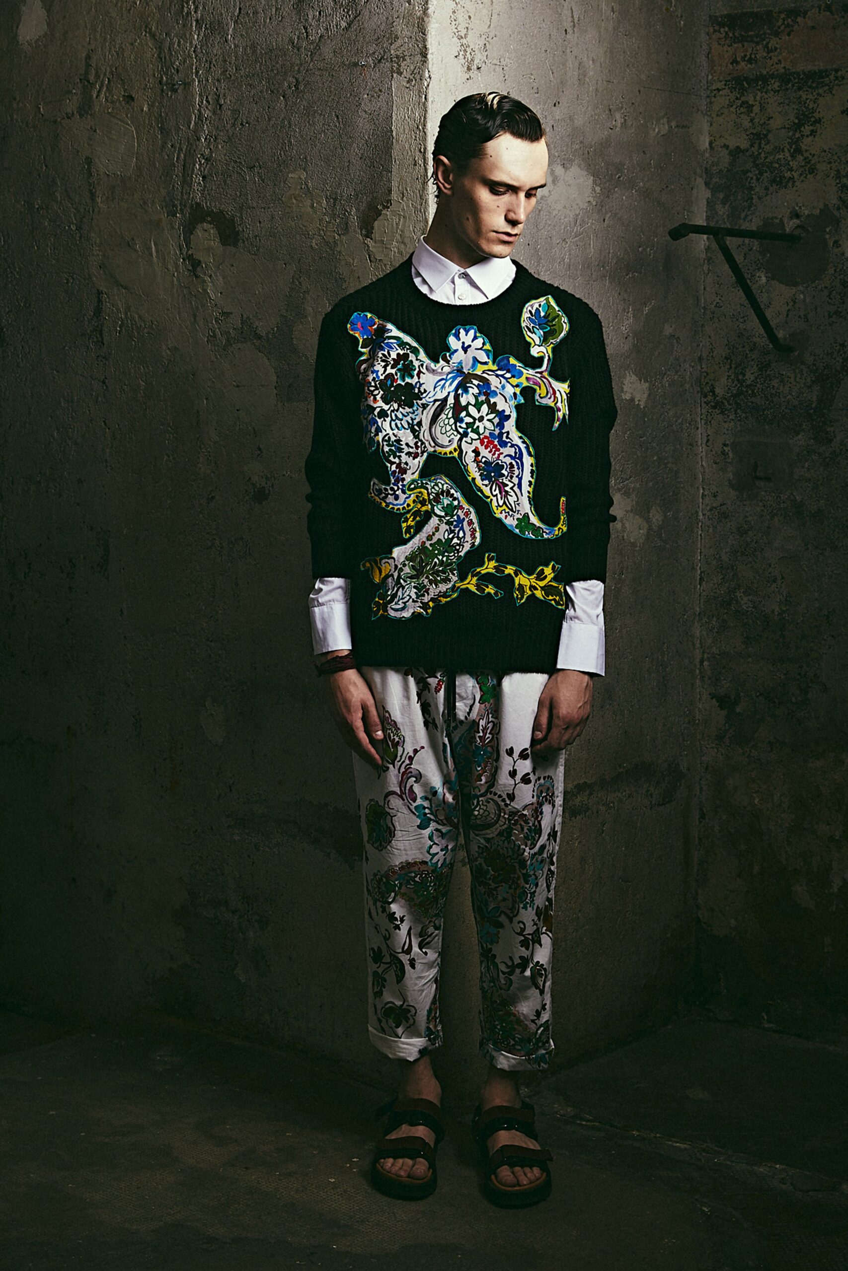 black embroidered sweater and printed pants