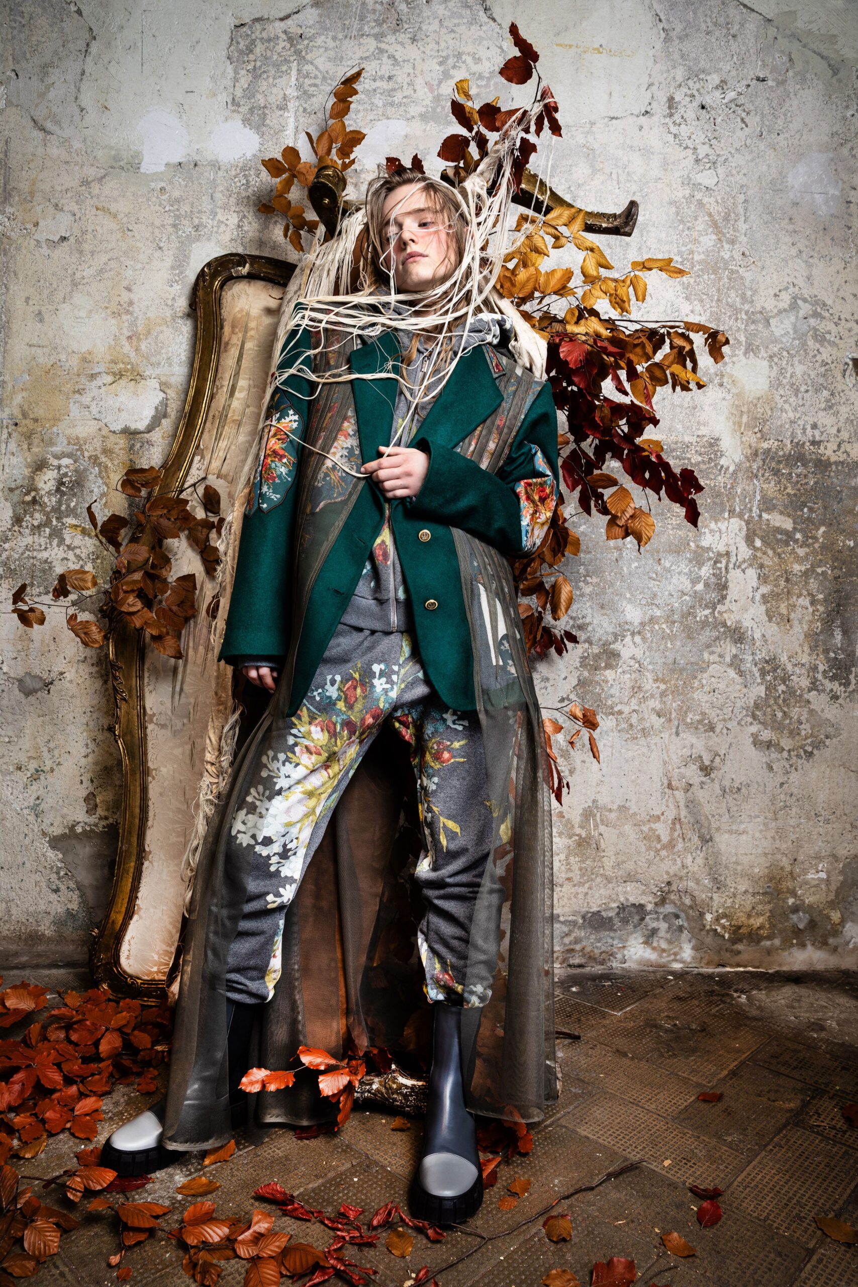 green embroidered coat with gray pants