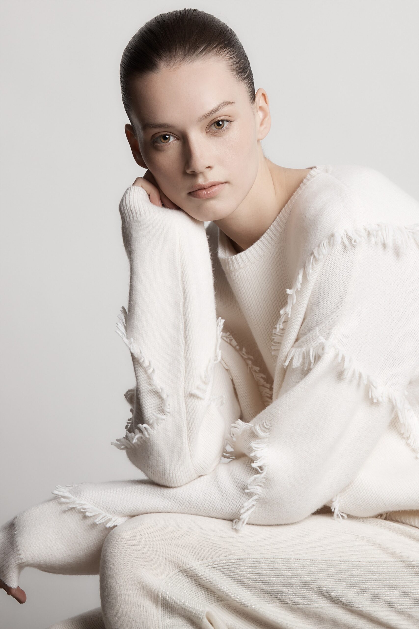 white relaxed sweater and beige pants