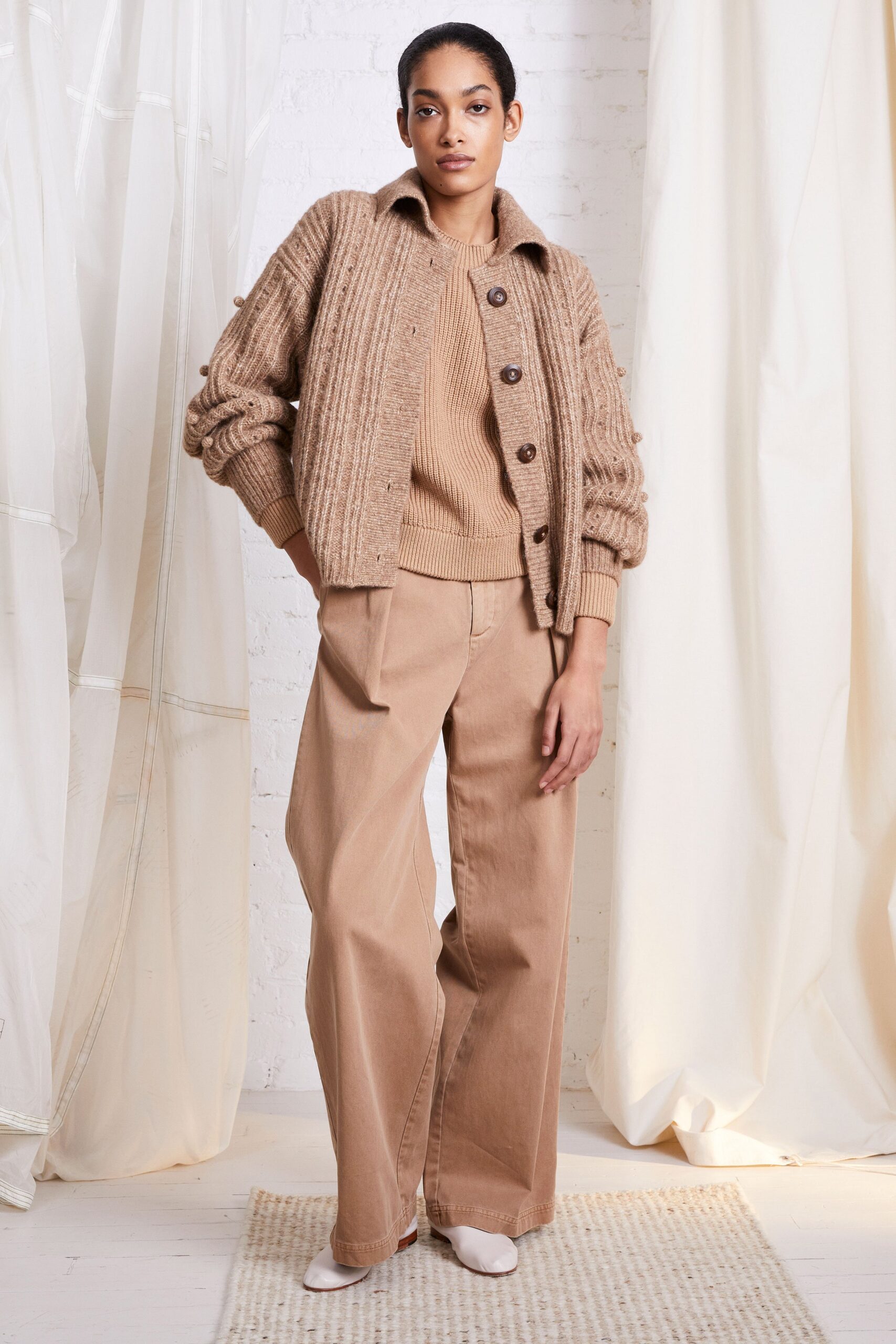 beige wool cardigan and sweater with tan pants