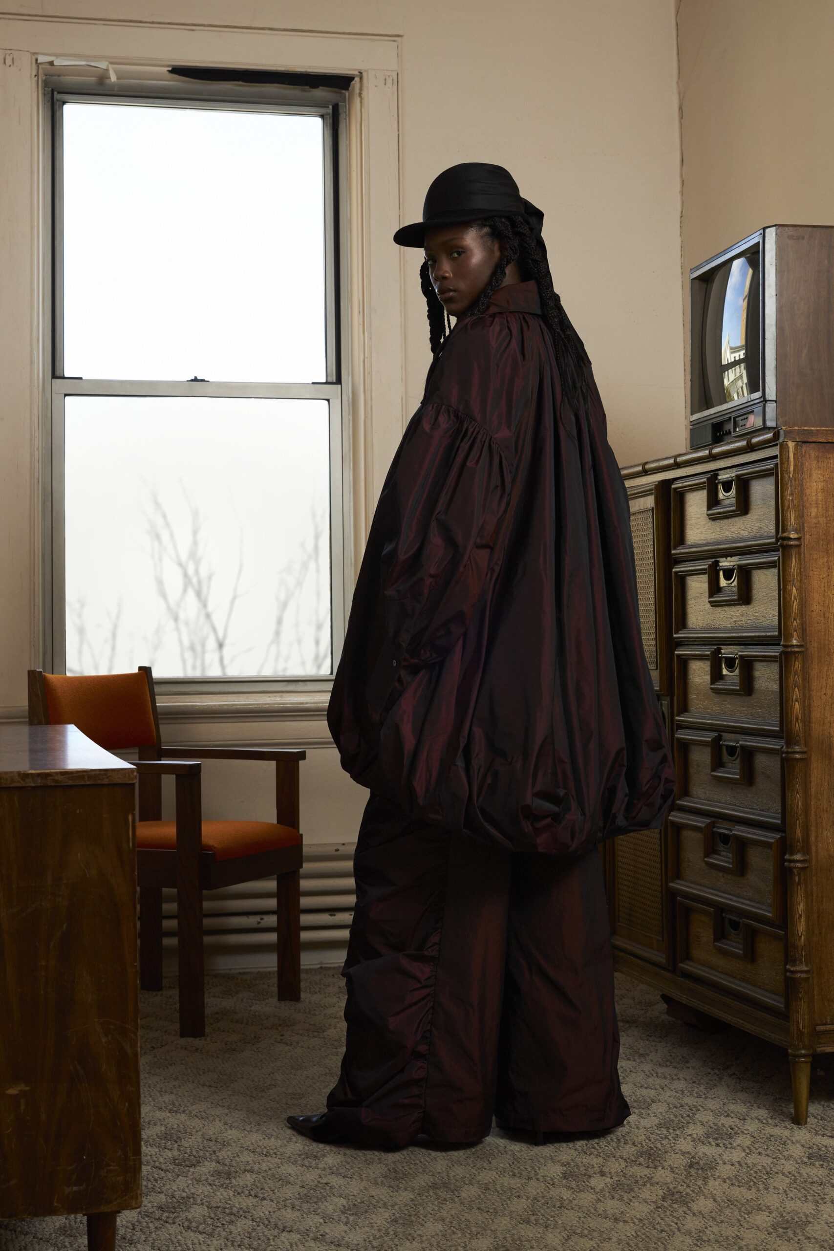 oversized black and red cape with wide-leg pants