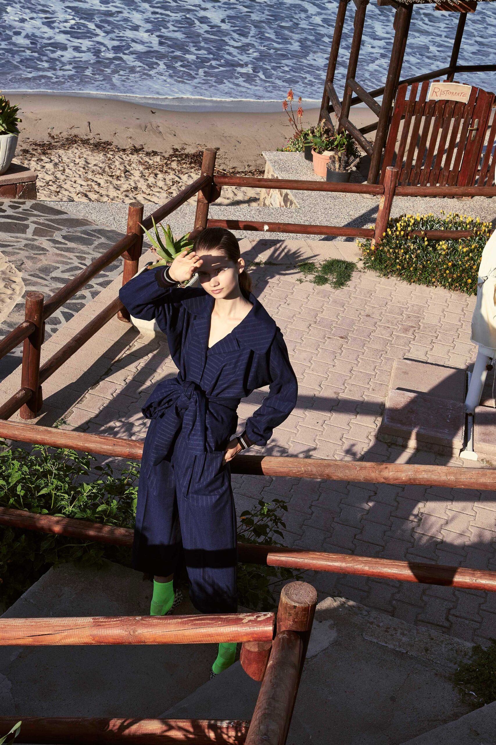 blue relaxed jumpsuit with green shoes