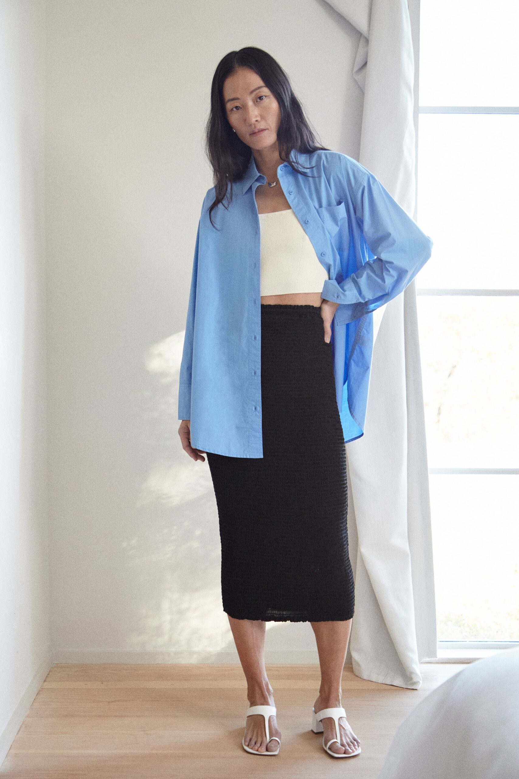 blue shirt white crop-top black skirt