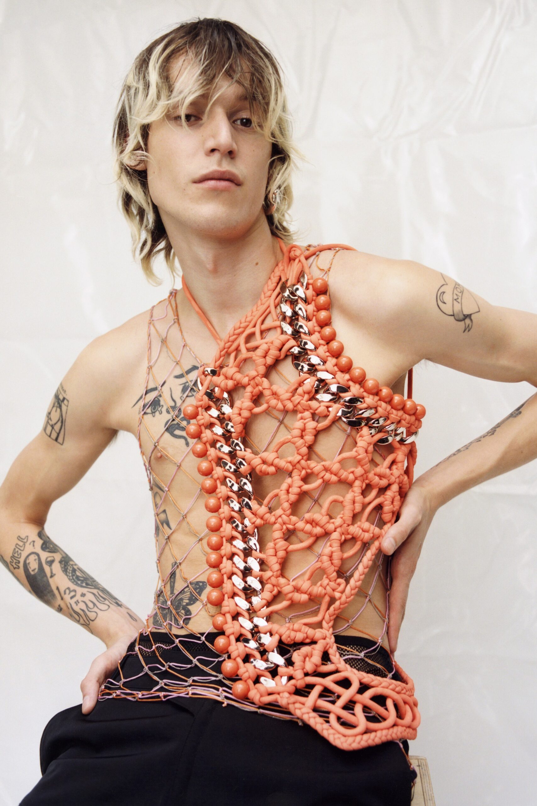 orange layered sleeveless top with black pants