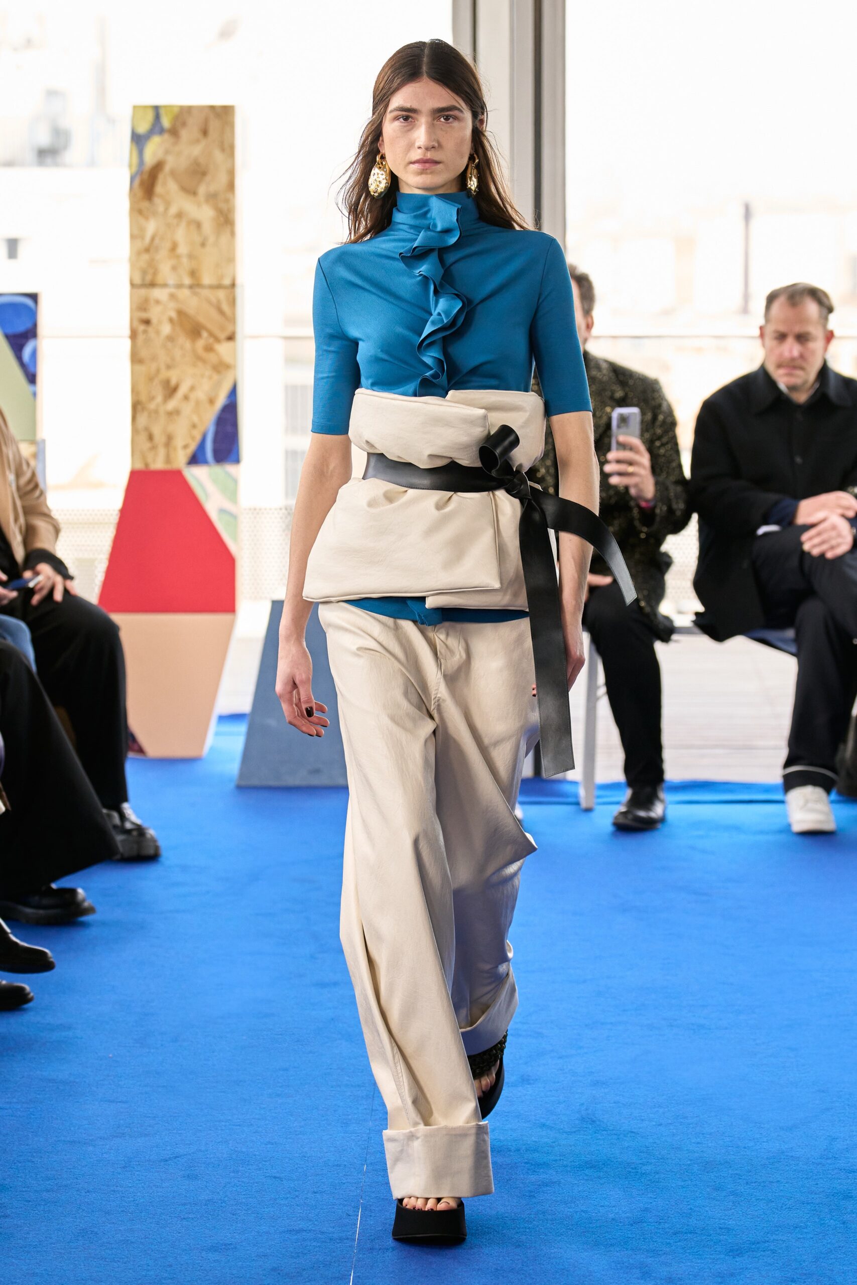 blue fitted top and beige wide-leg pants