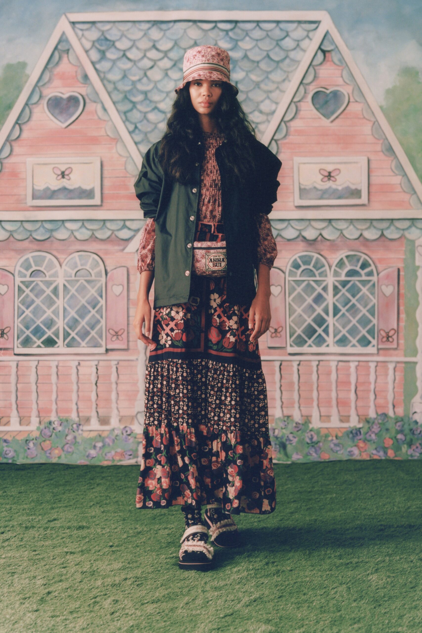 black relaxed jacket with pink blouse and multi-tiered skirt