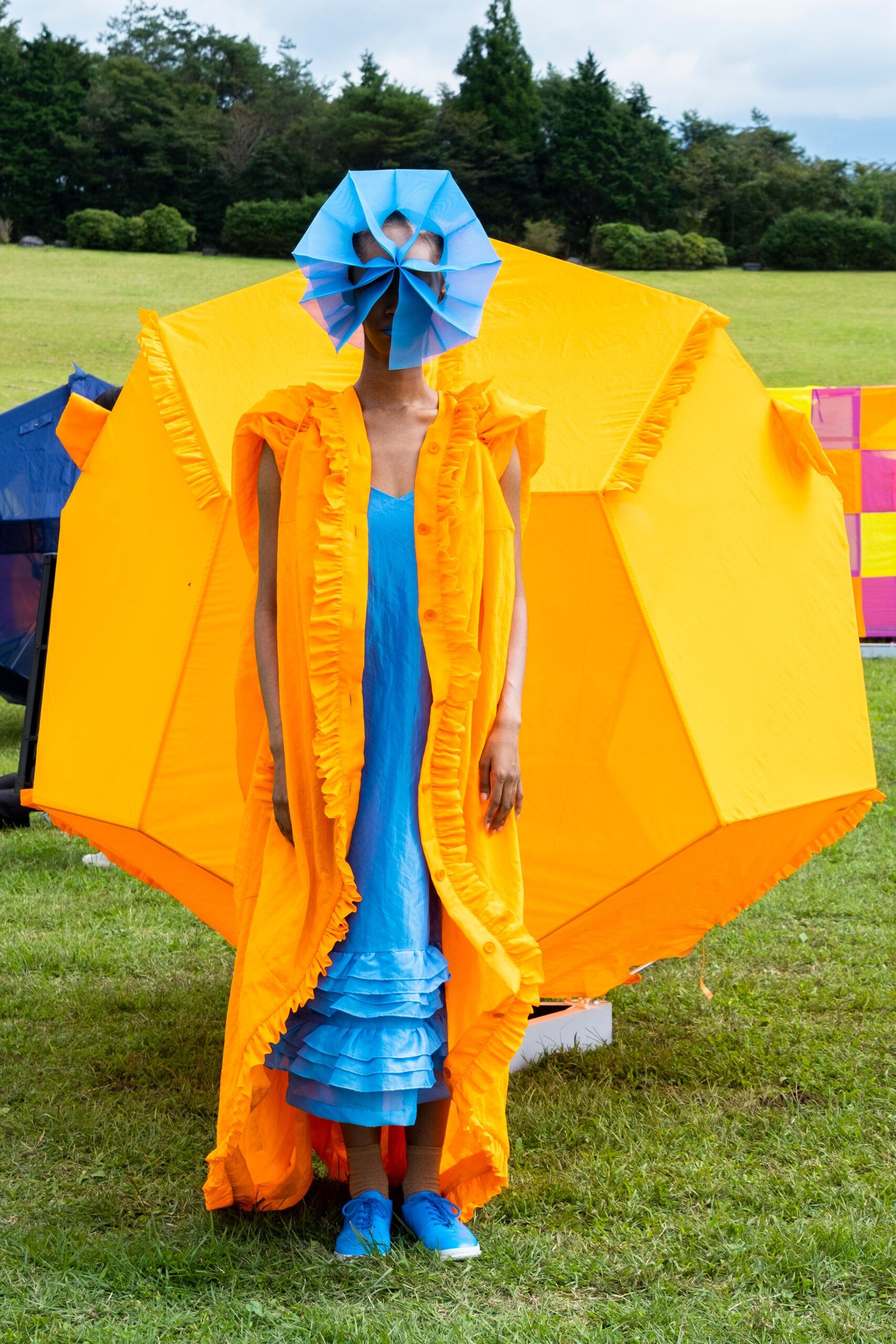blue tiered dress with orange cape