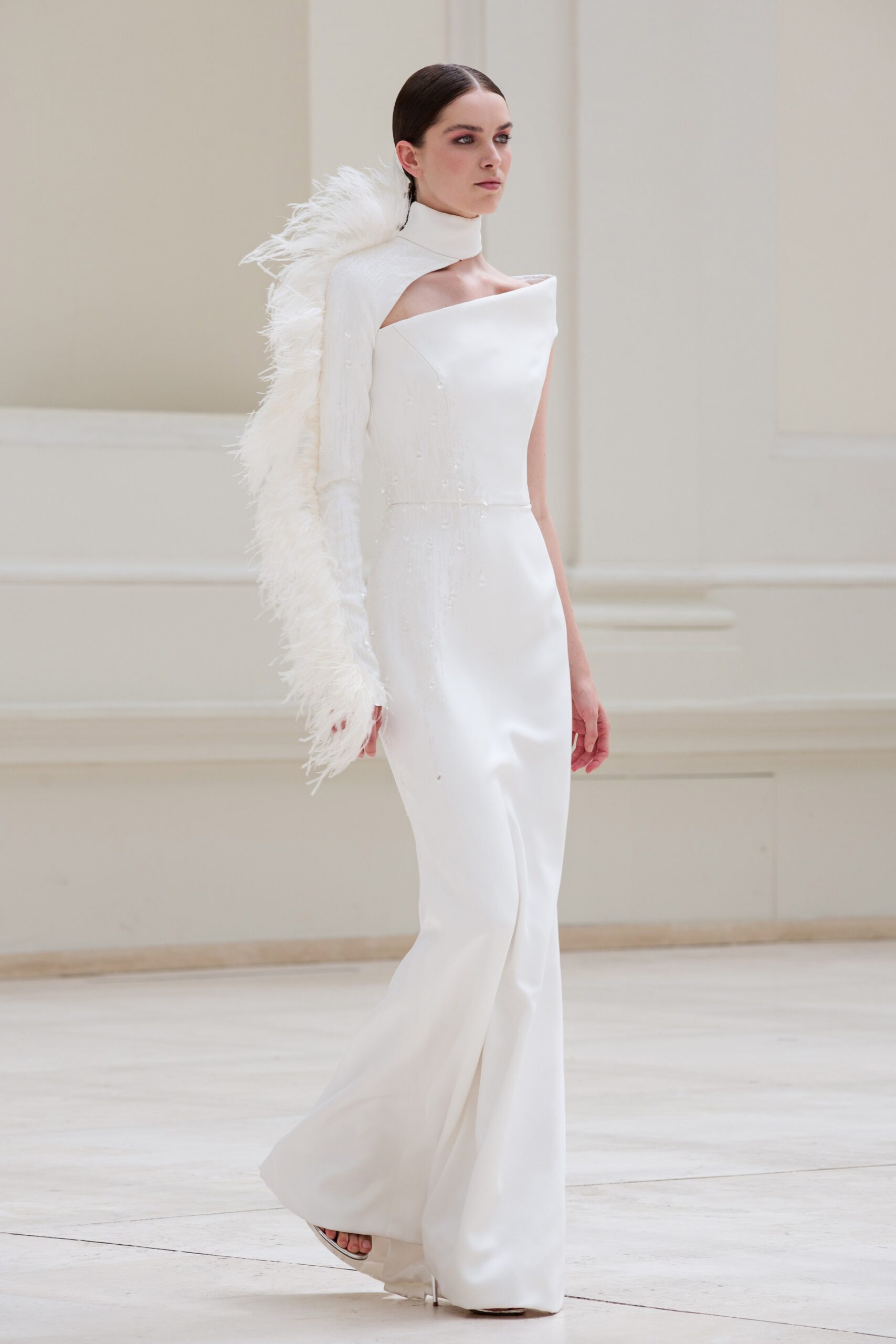 white silk fitted gown with feather cape