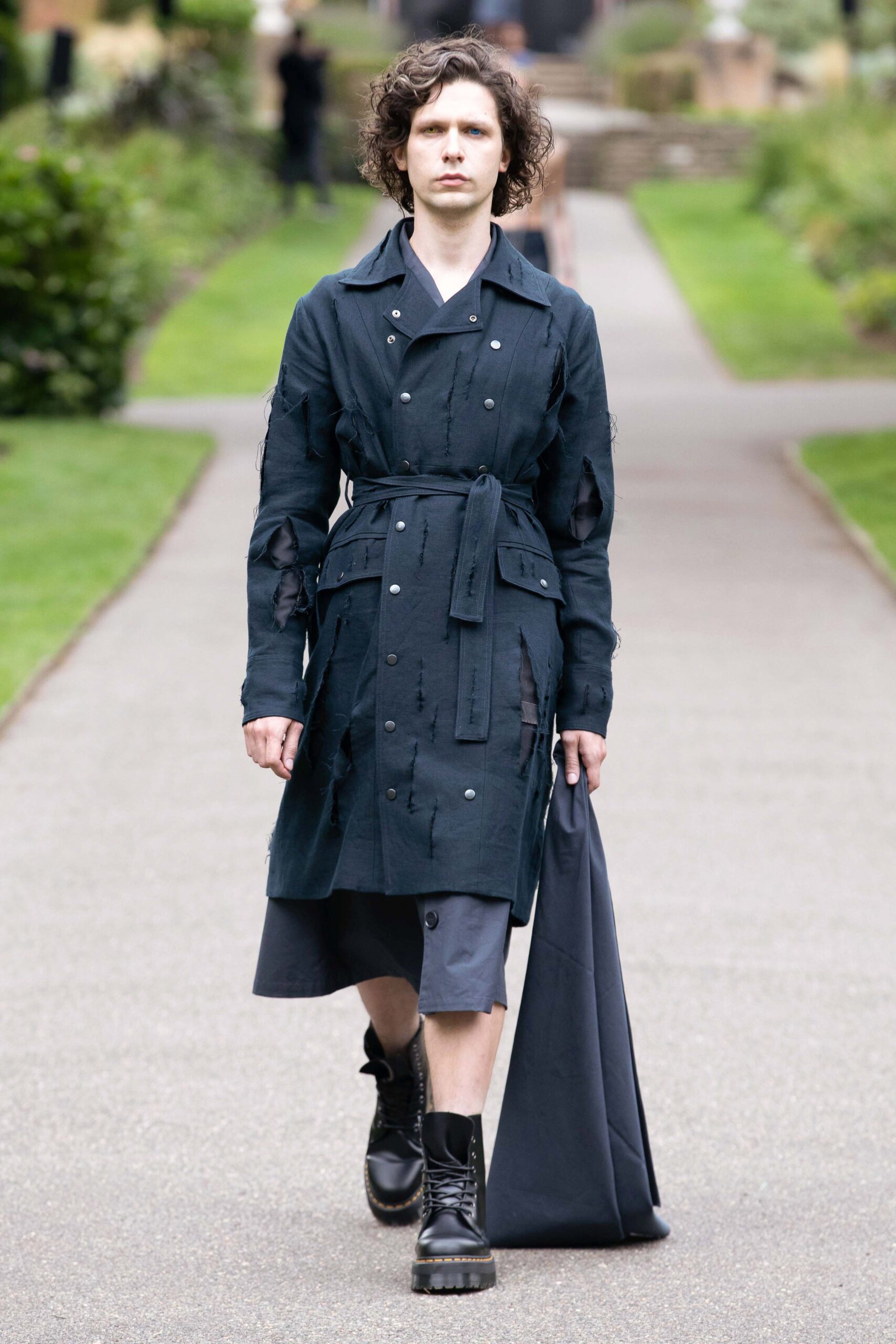 black distressed coat with gray pants