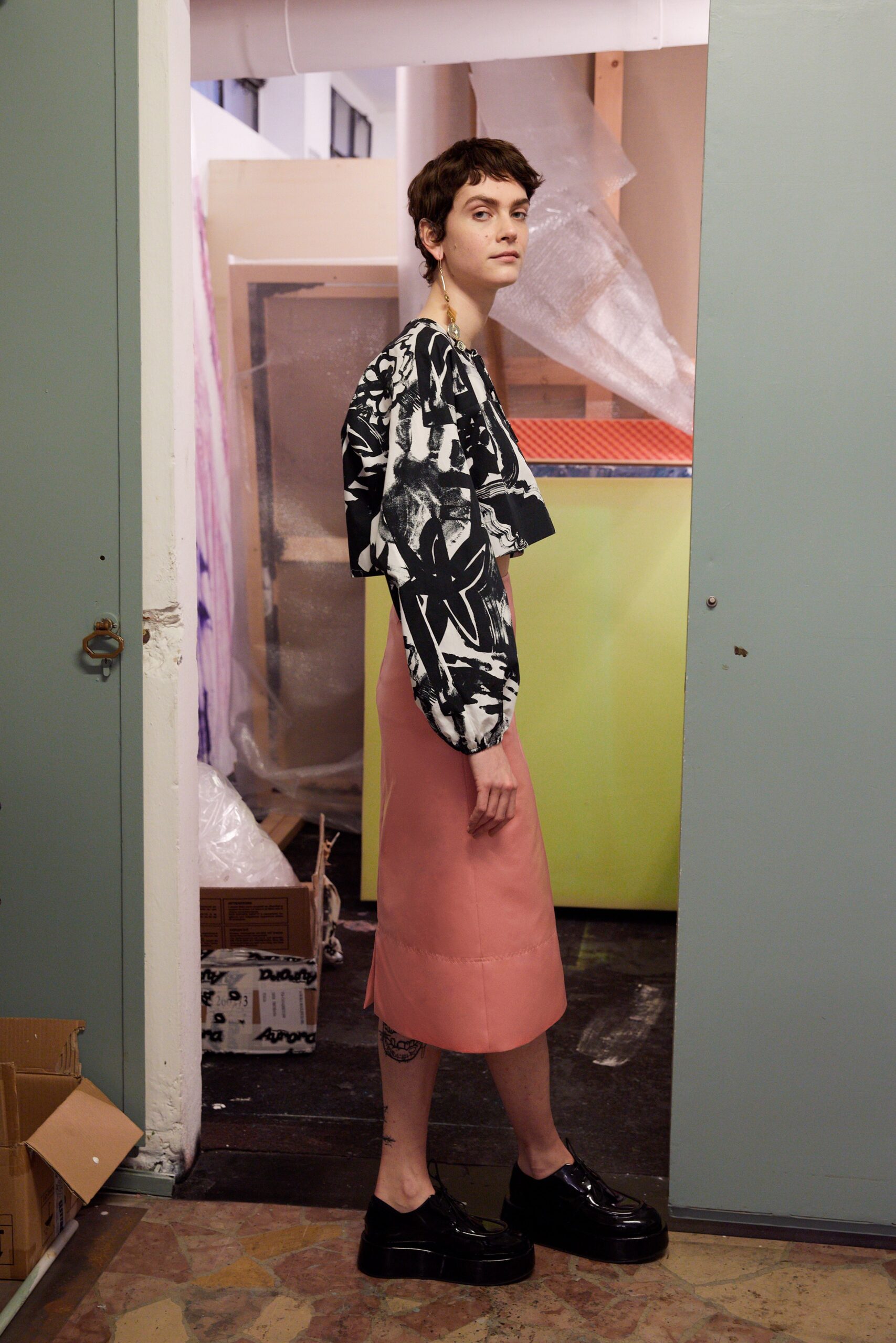 black and white printed top with pink midi skirt