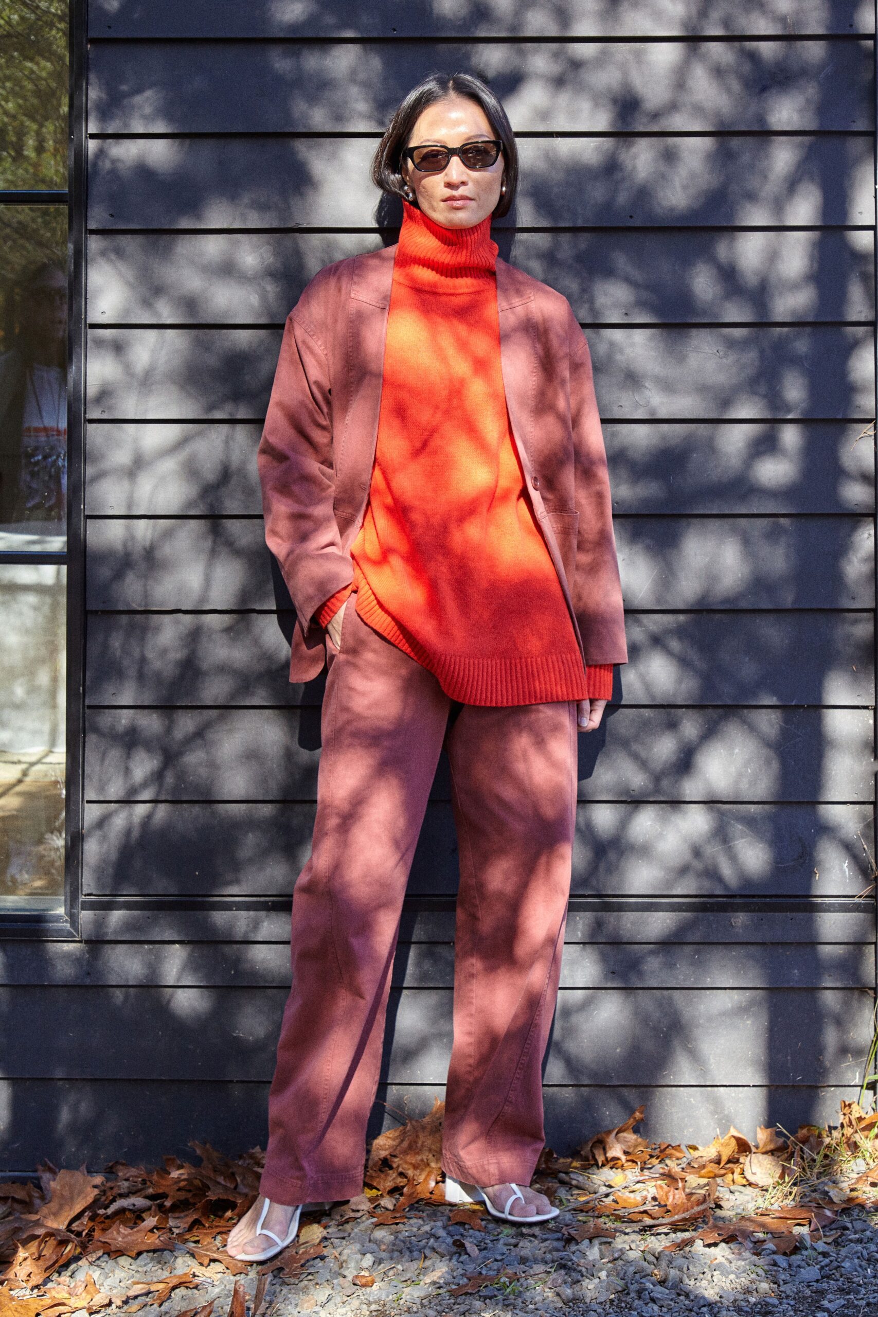 red wool sweater with brown jacket