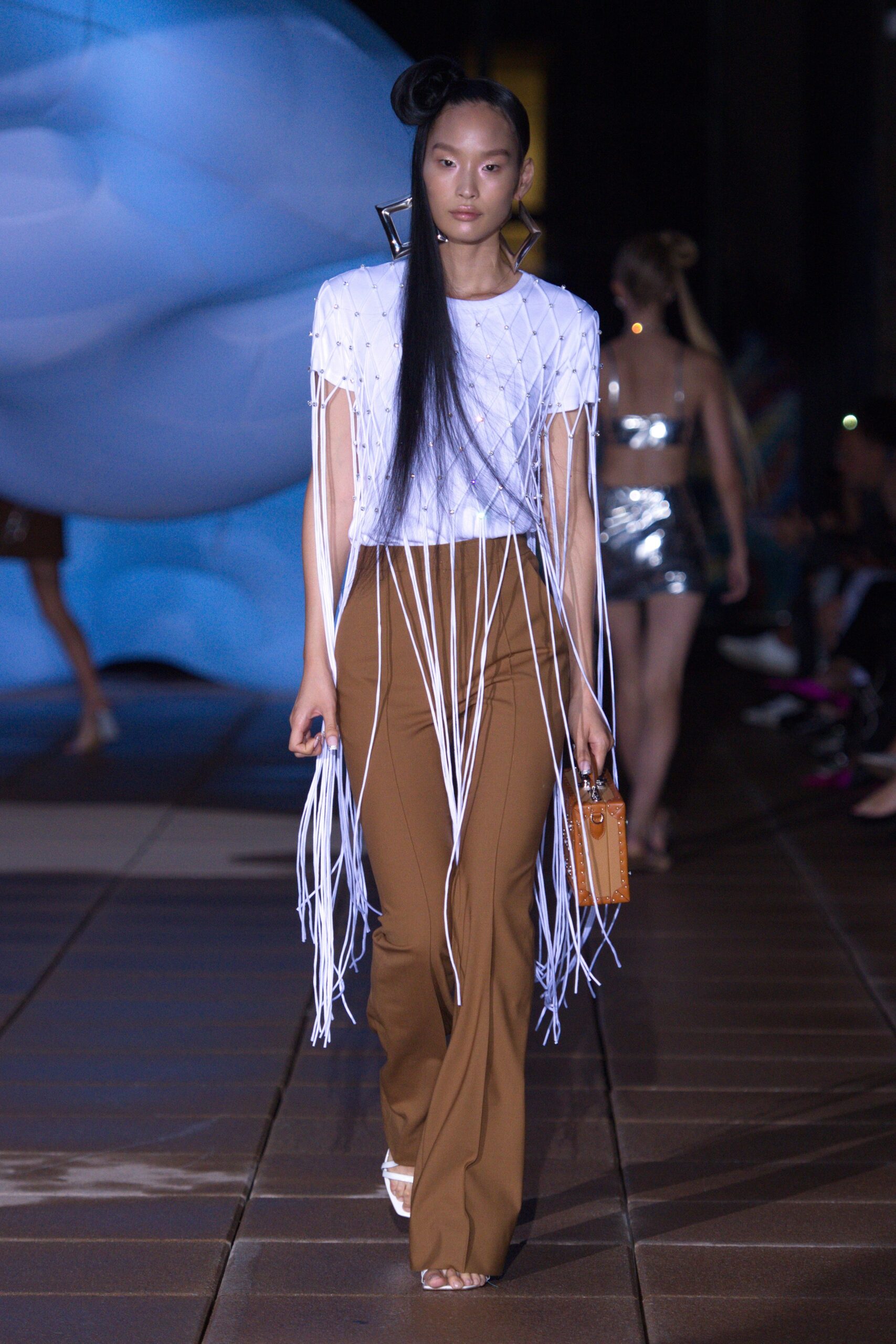 white fringed top with brown flared pants