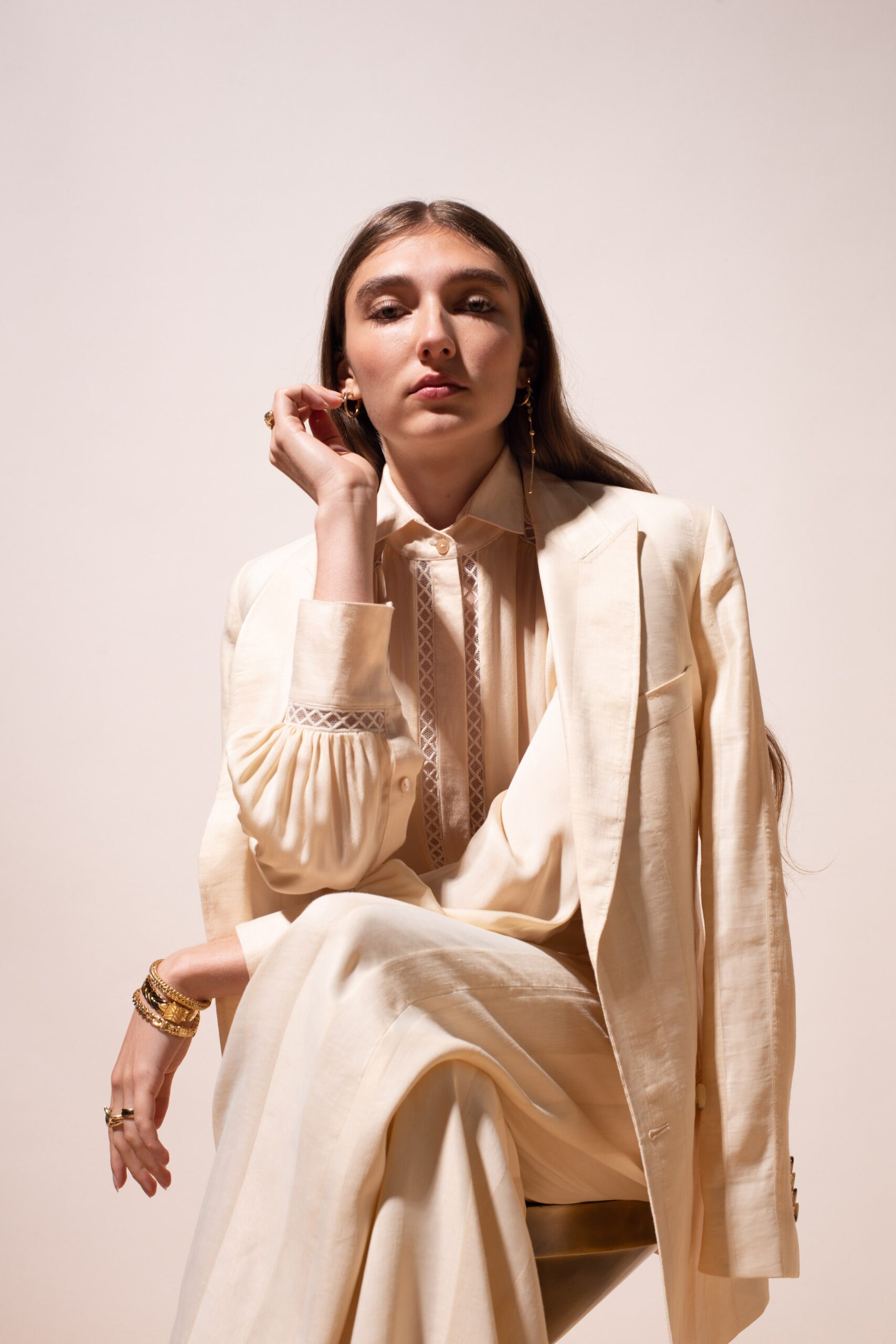 beige tailored suit with ivory blouse