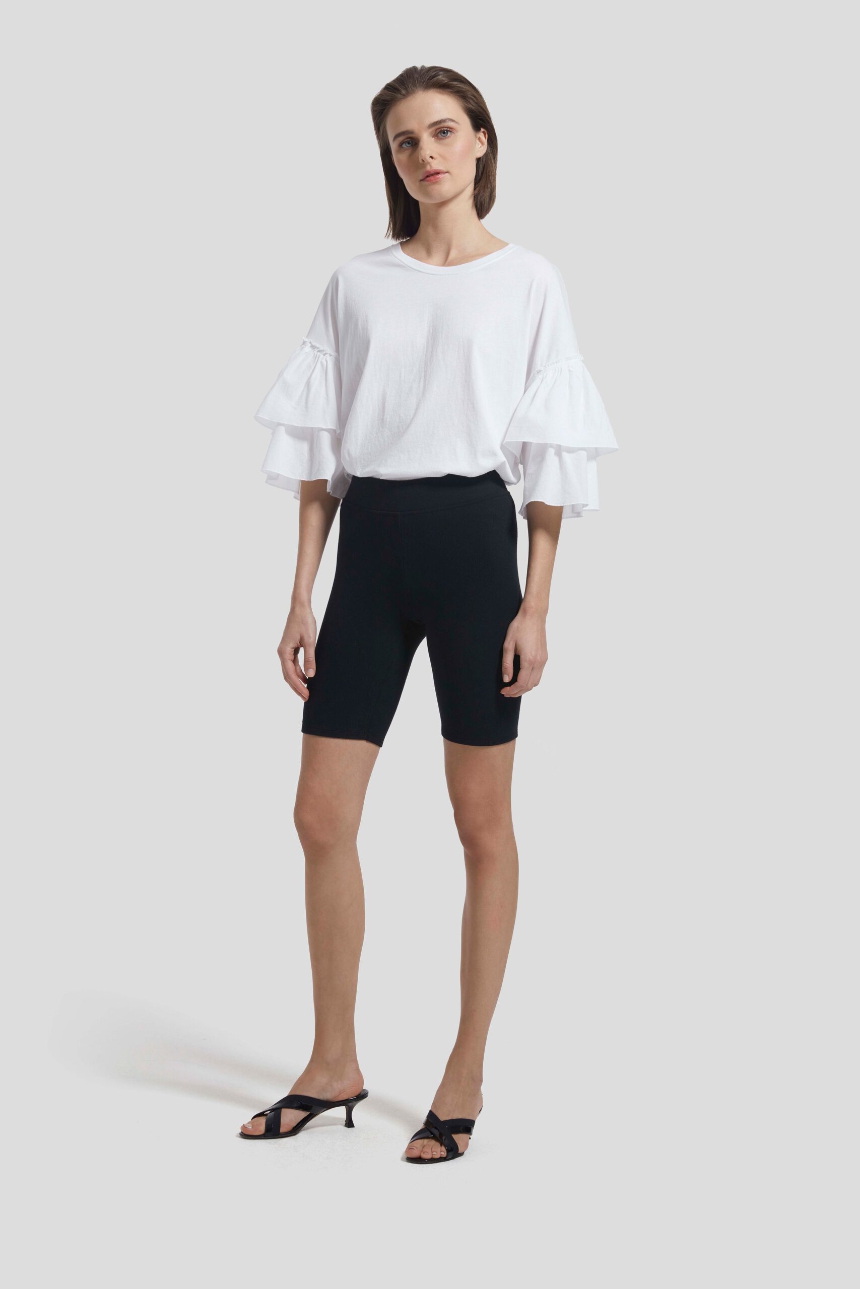 white ruffled top with black shorts