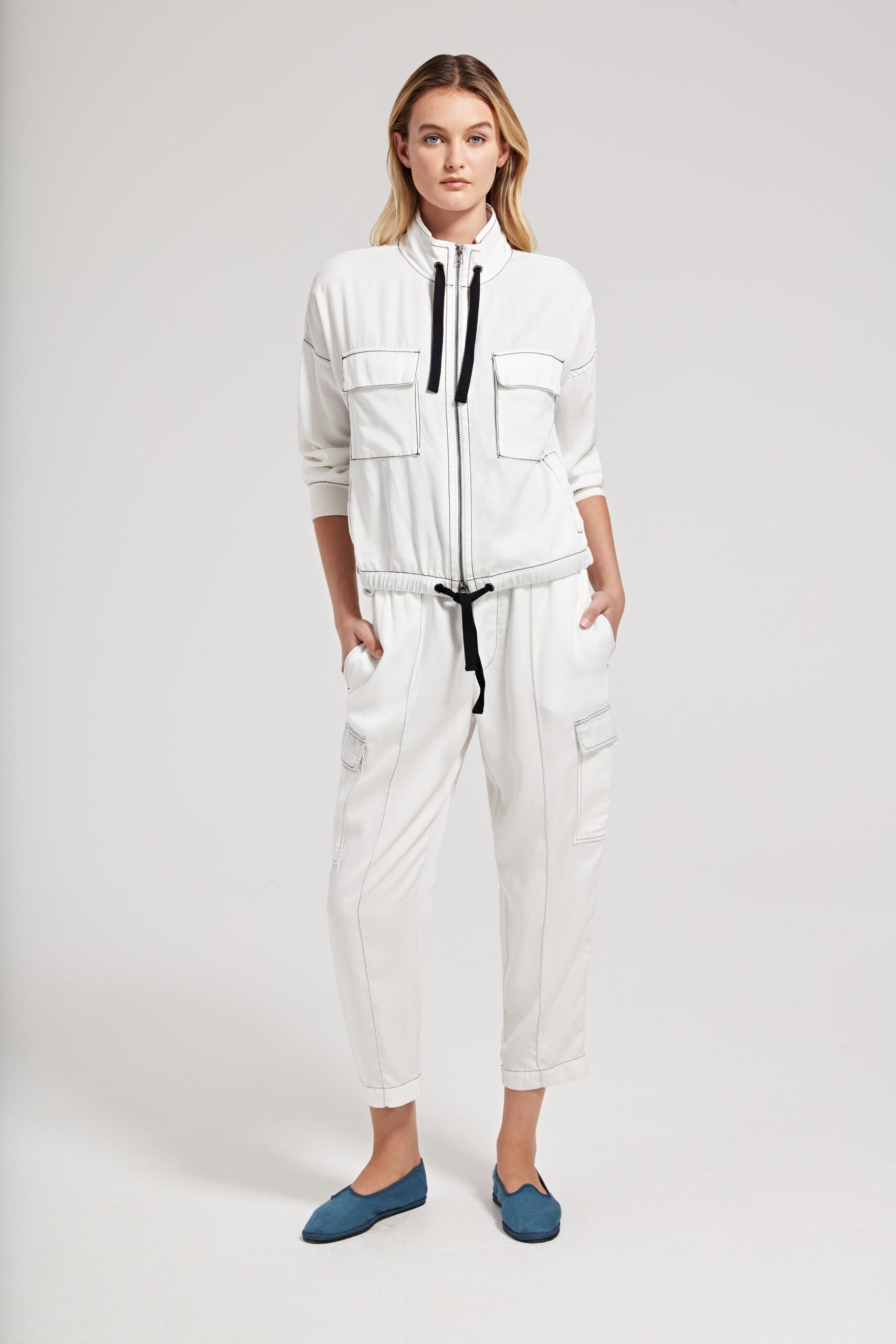 white relaxed jumpsuit with blue shoes