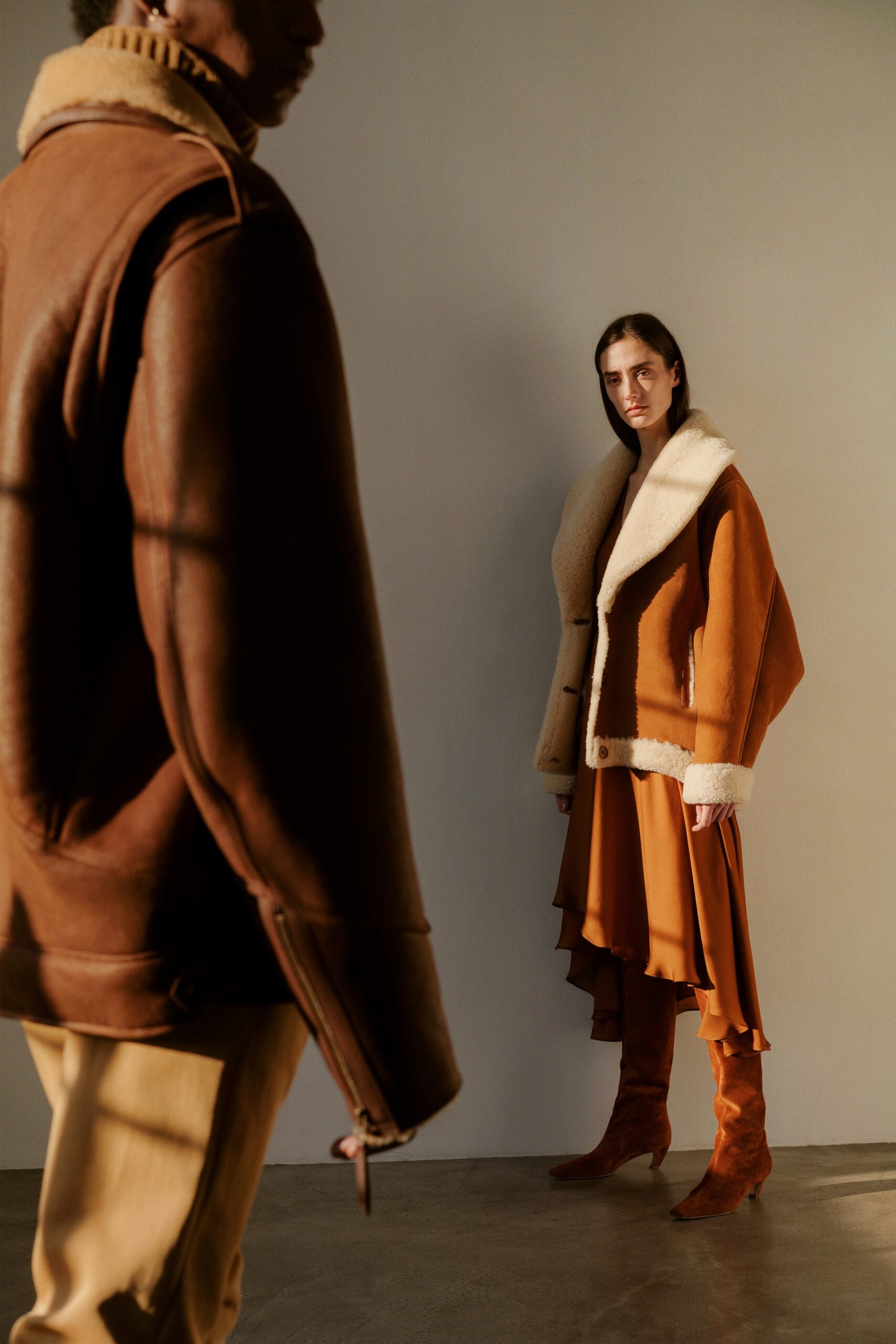 orange silk tiered dress with brown jacket