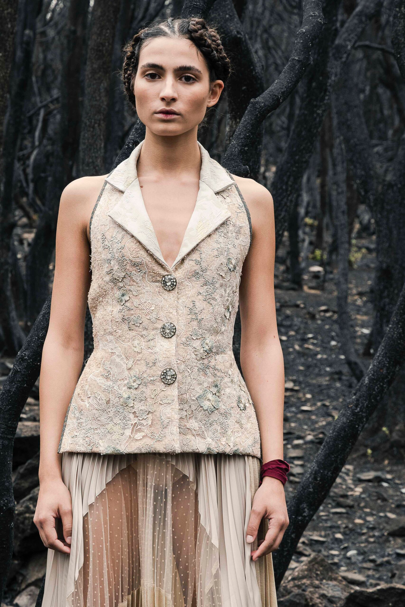 beige embroidered vest and pleated skirt