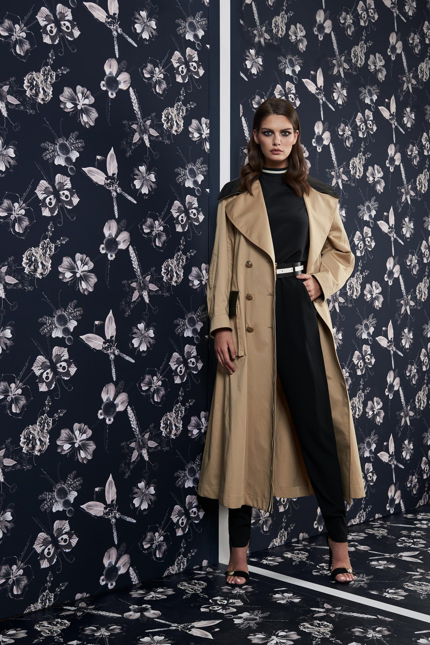 beige trench coat and black jumpsuit