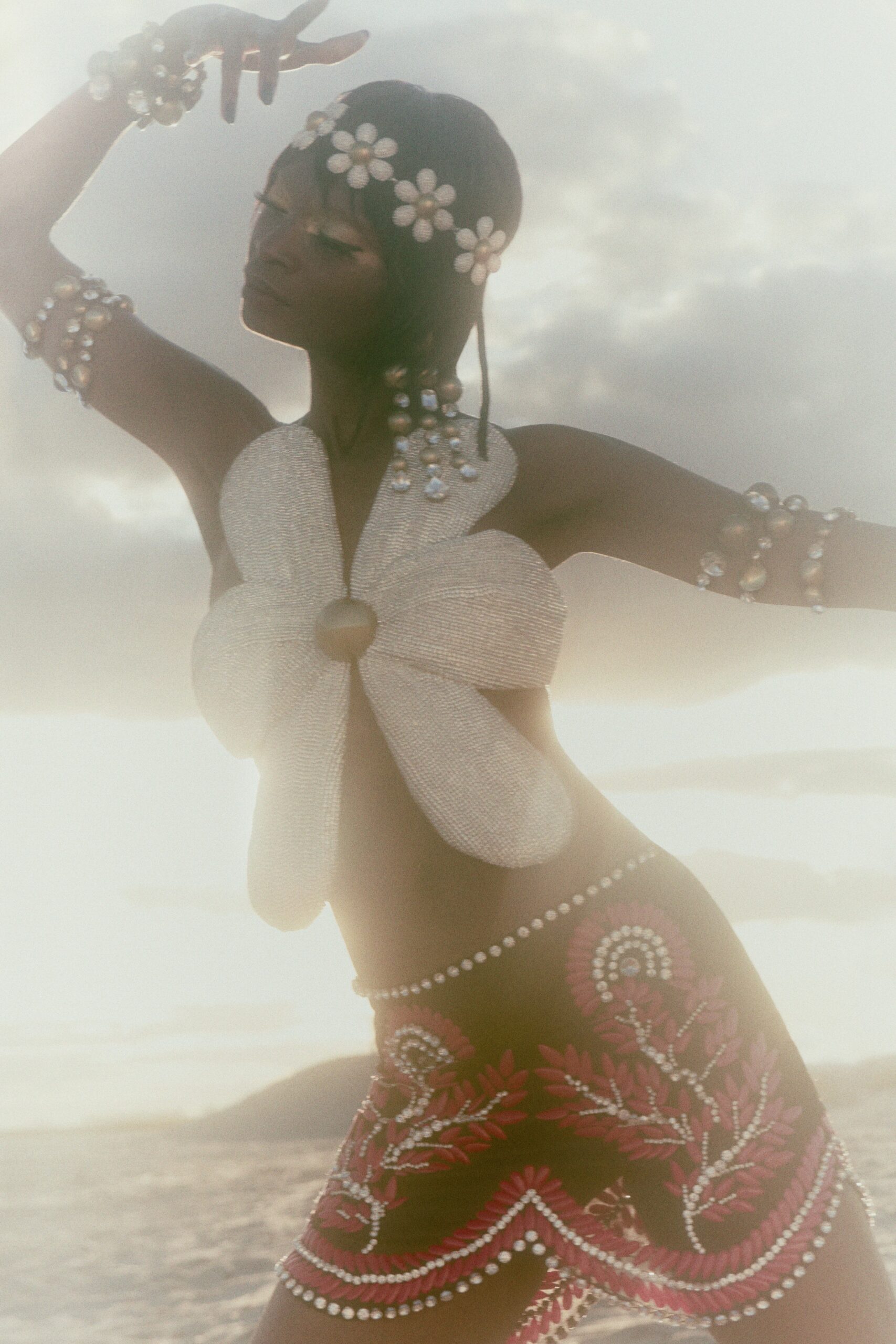 white floral top and red embroidered skirt