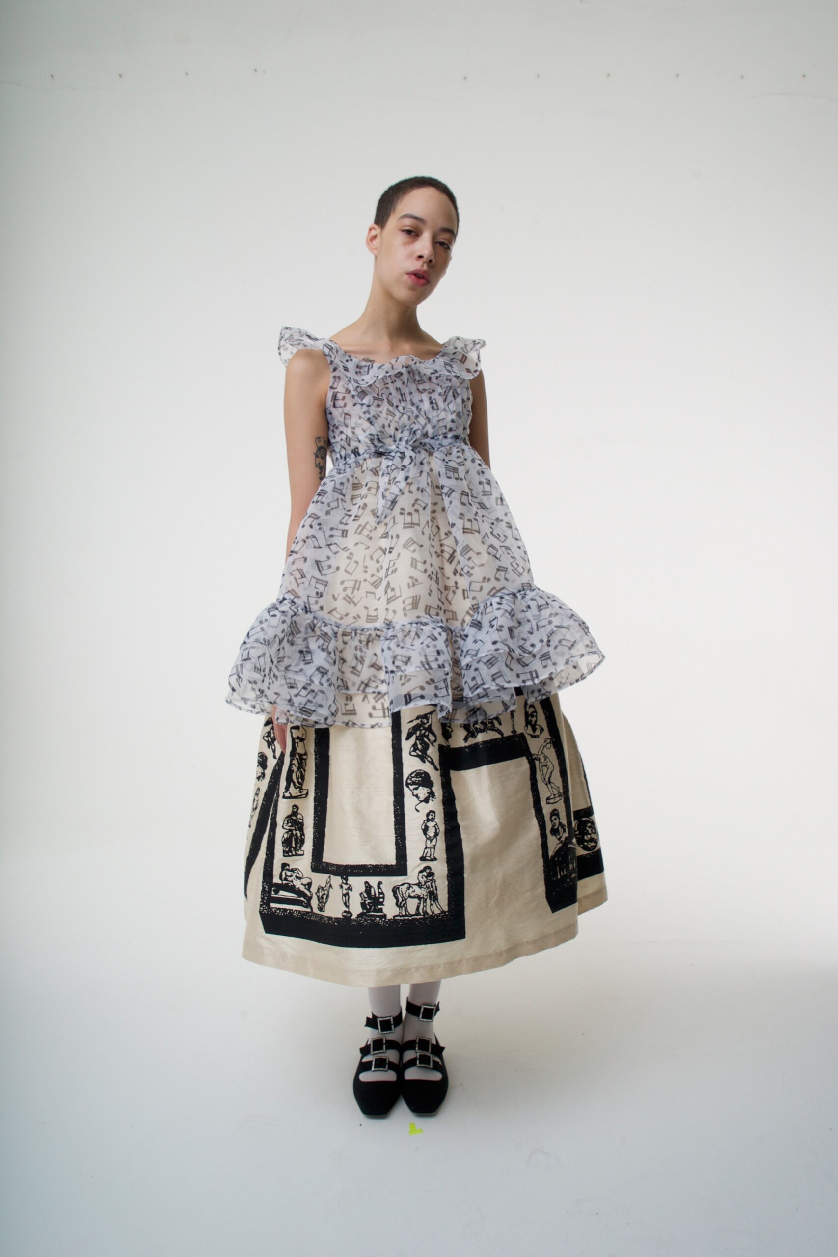 white ruffled top and beige tiered skirt