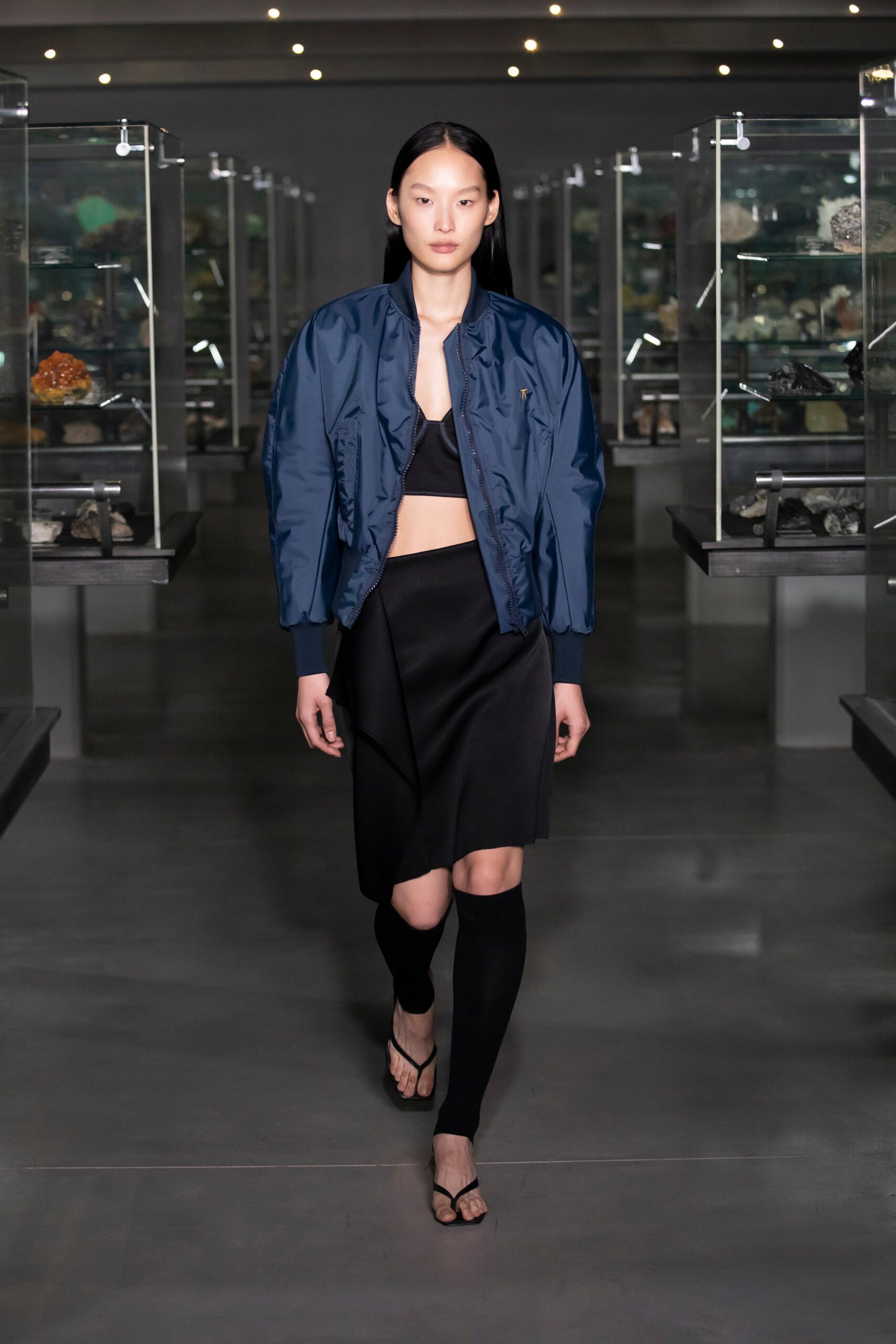 blue fitted jacket with black top and skirt
