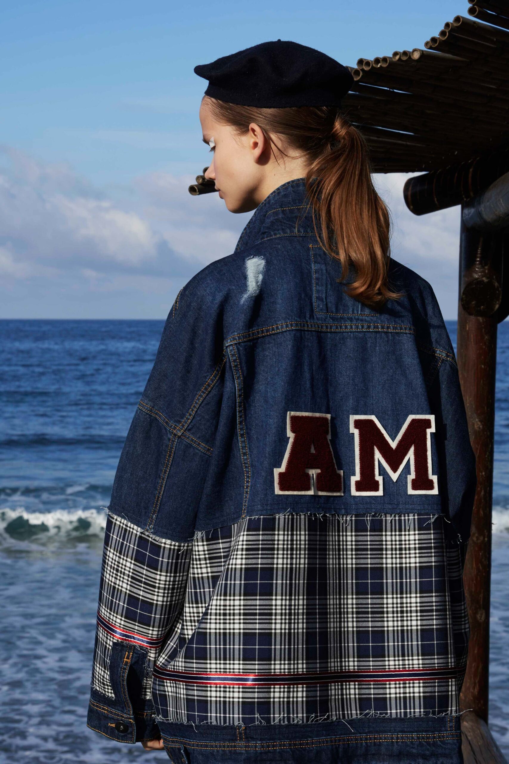 blue patchwork denim jacket with black hat
