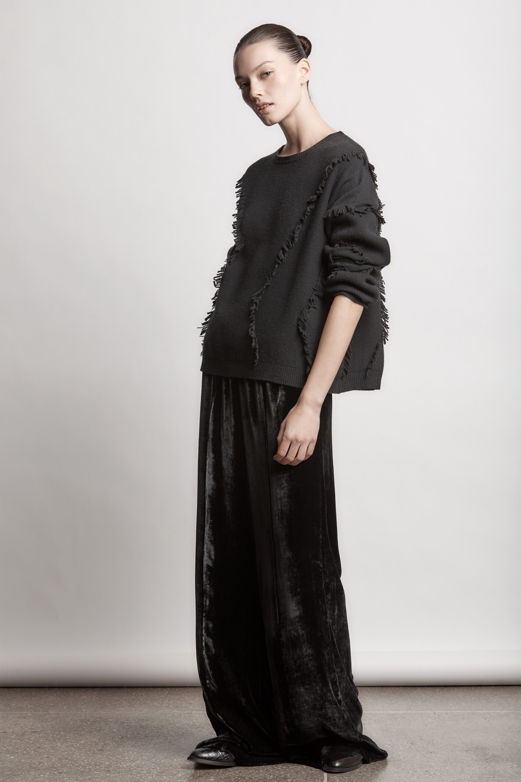 black oversized sweater and velvet pants