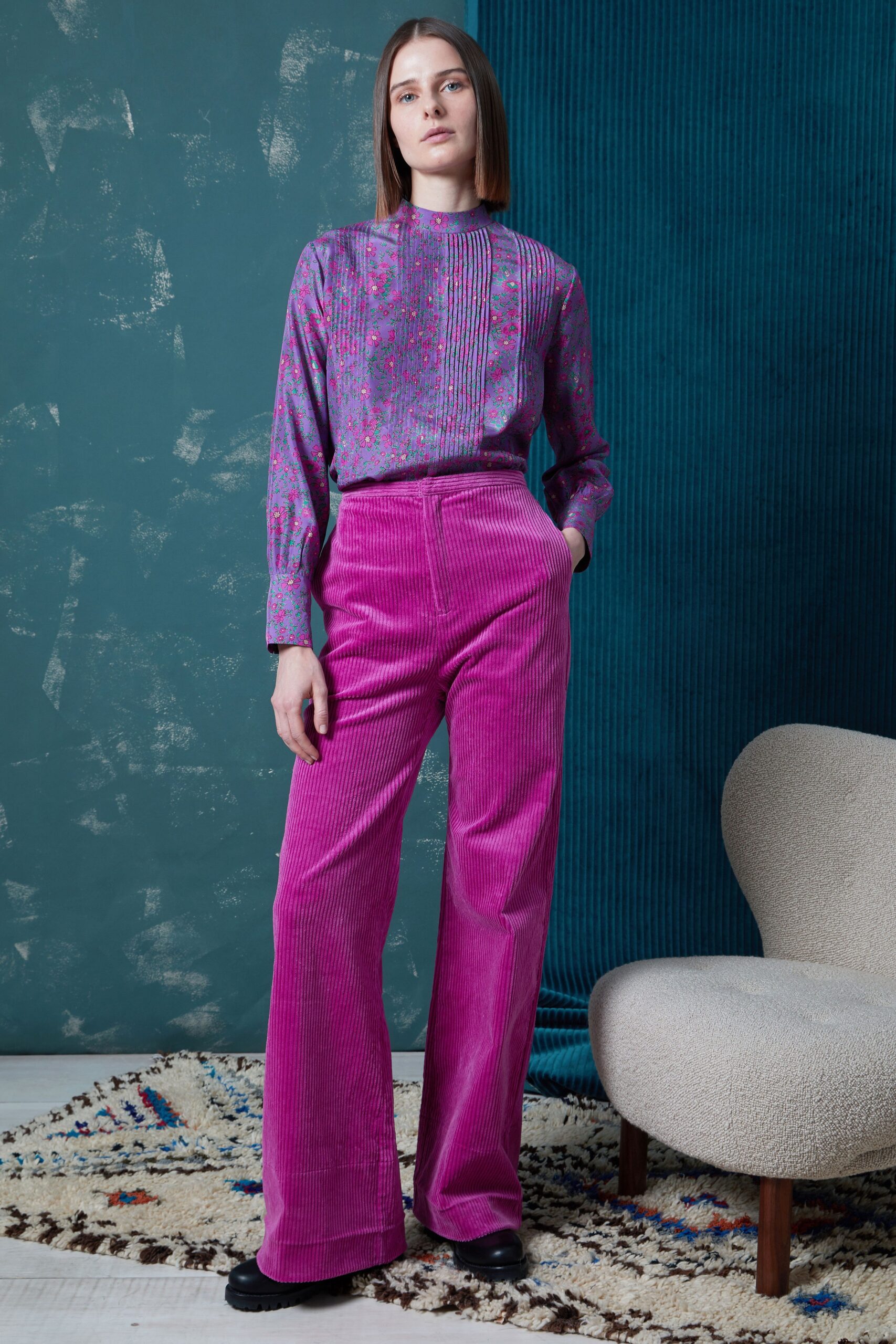 purple pleated shirt and pink flared pants
