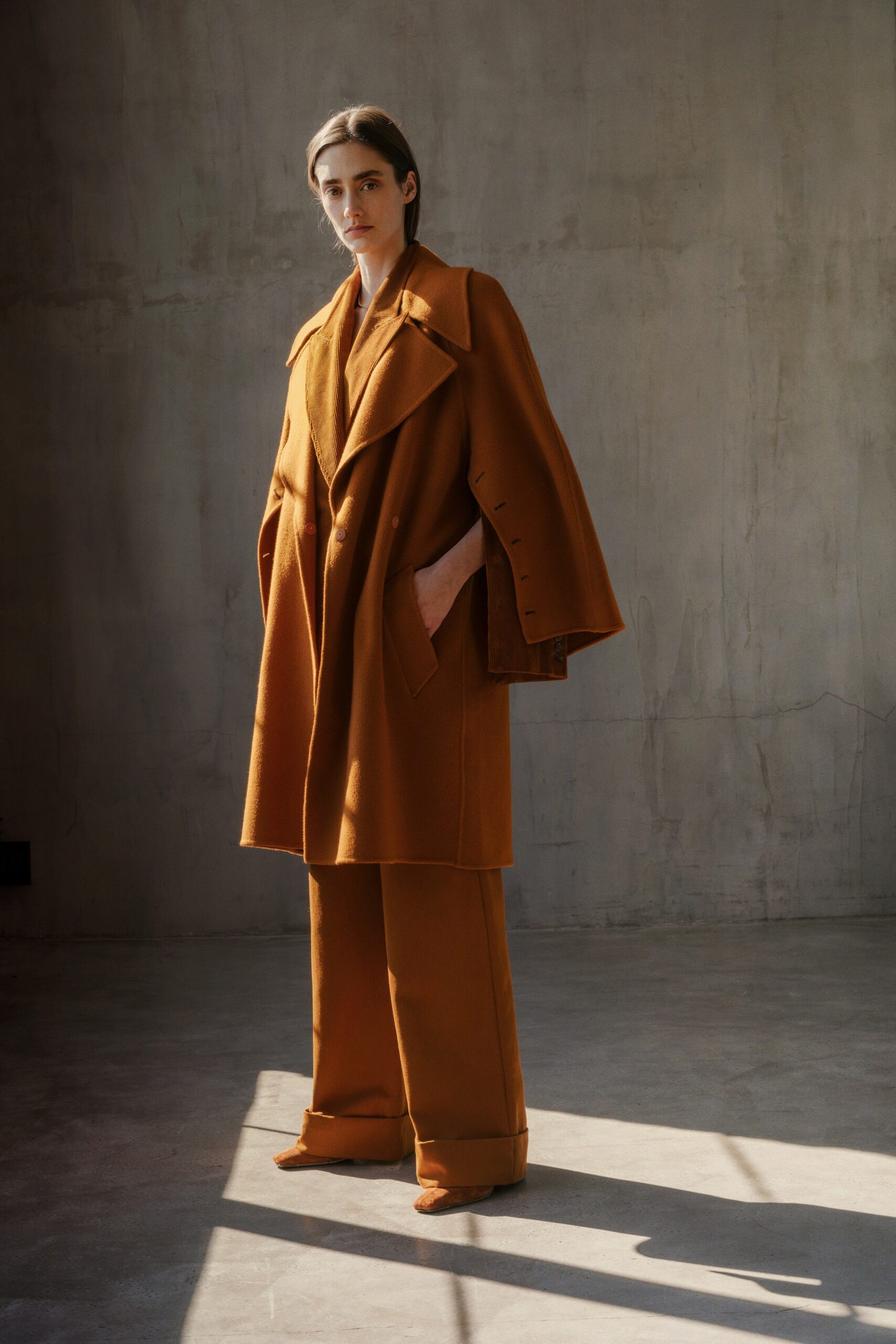 orange oversized coat and tailored pants