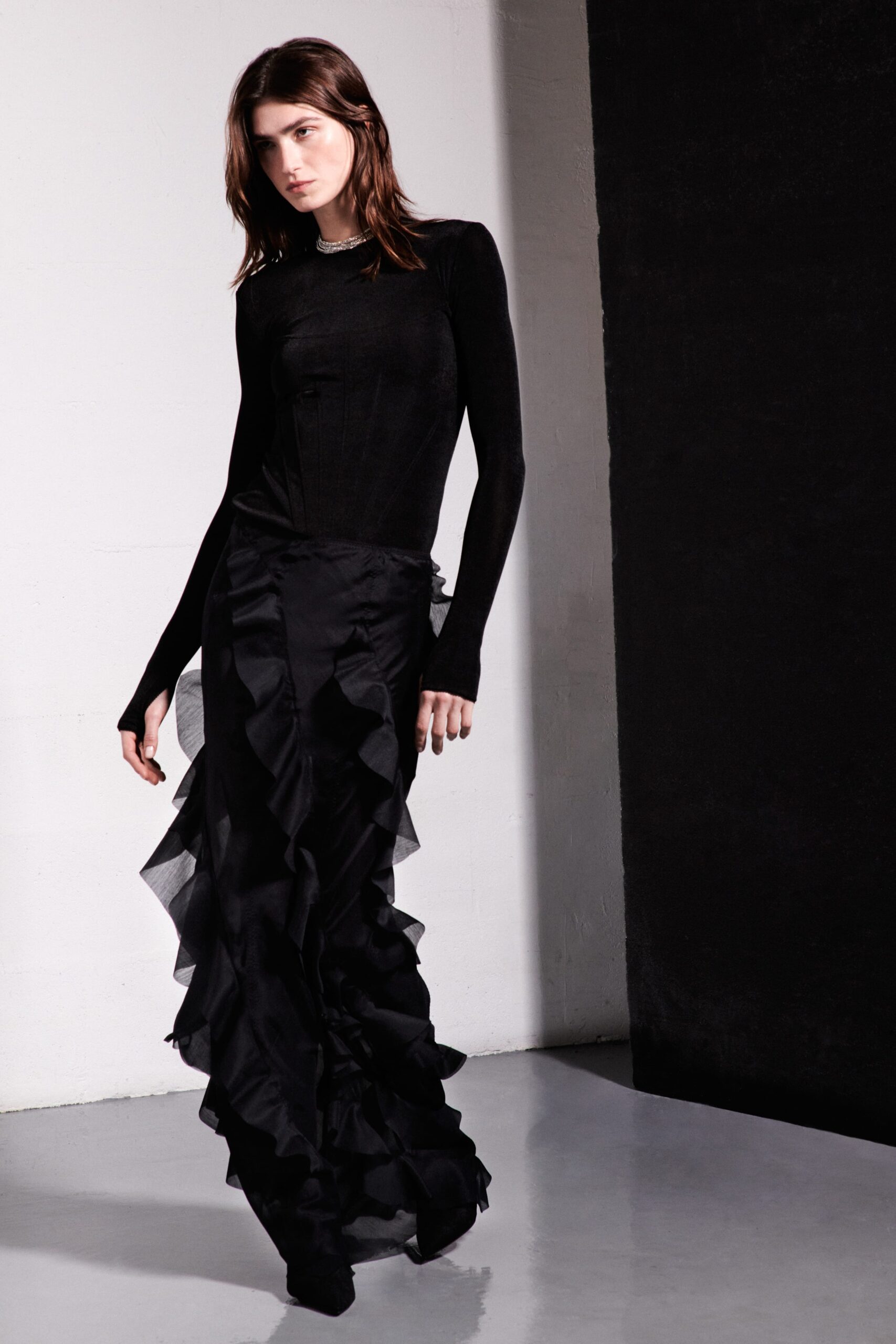 black fitted top and ruffled skirt