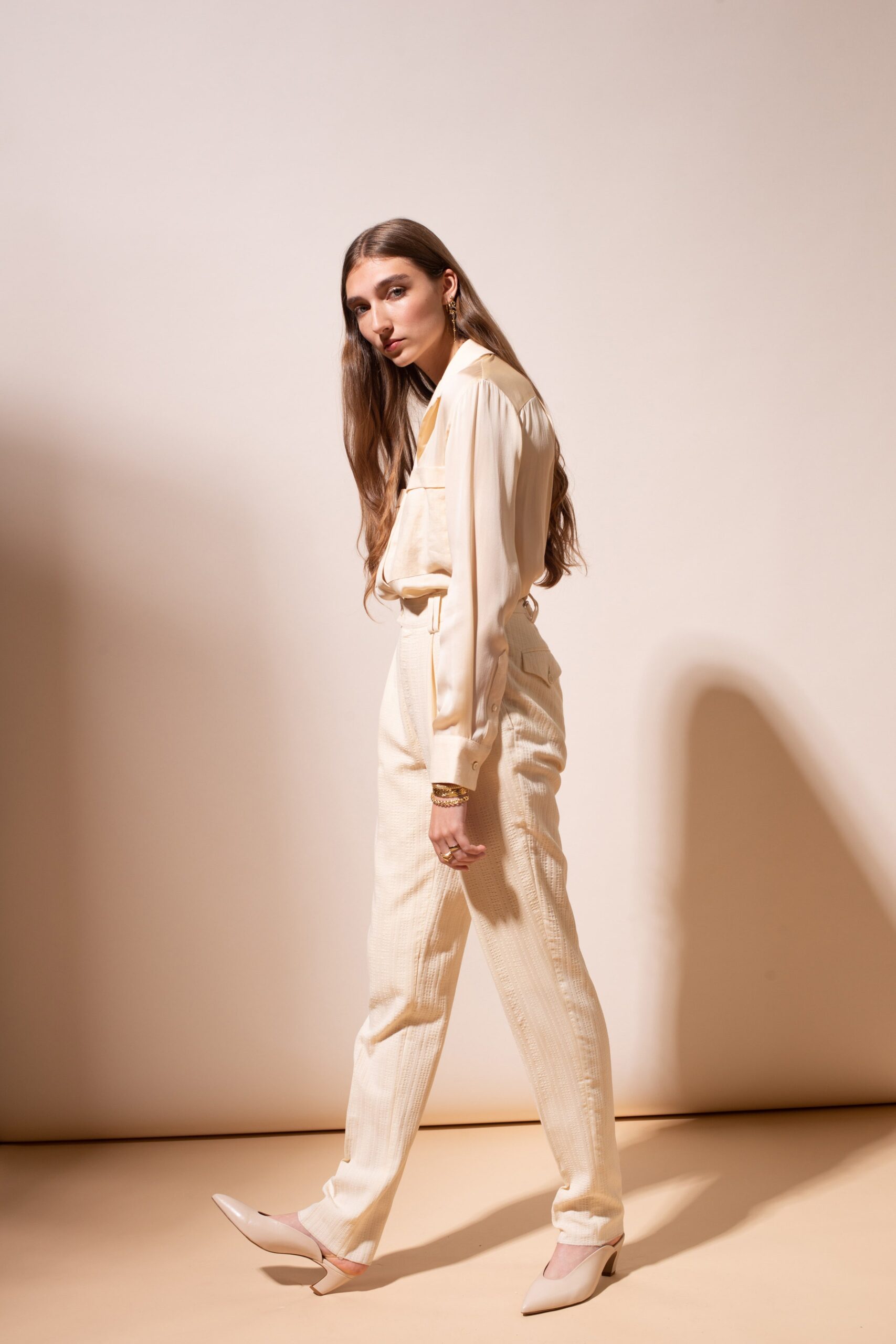 beige silk shirt and tailored pants