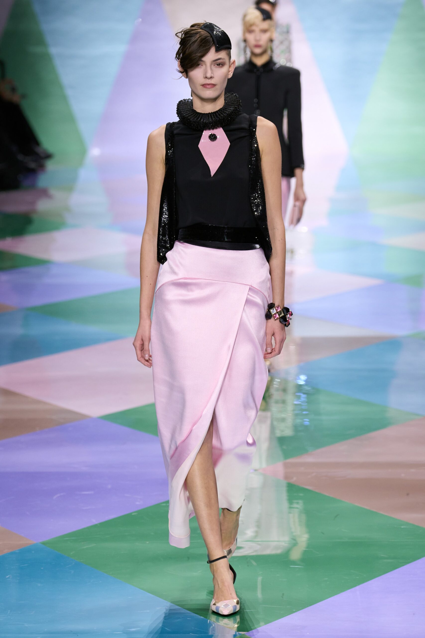 black silk sleeveless top and pink skirt