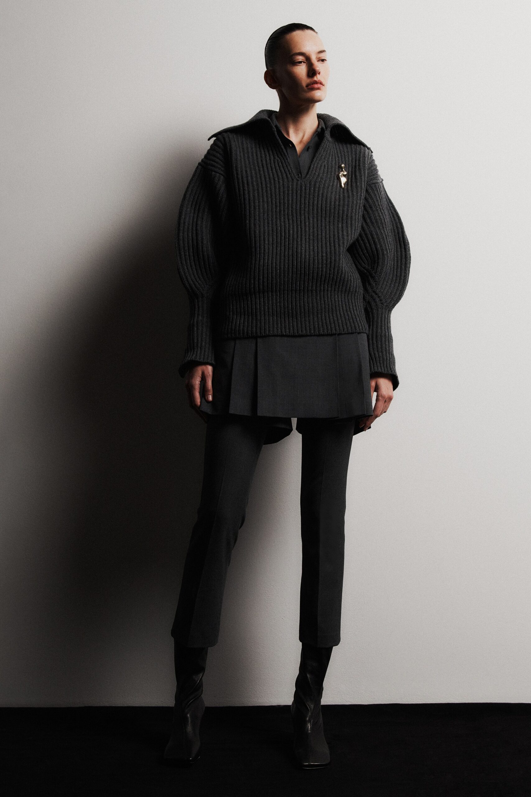 black wool sweater gray pleated skirt