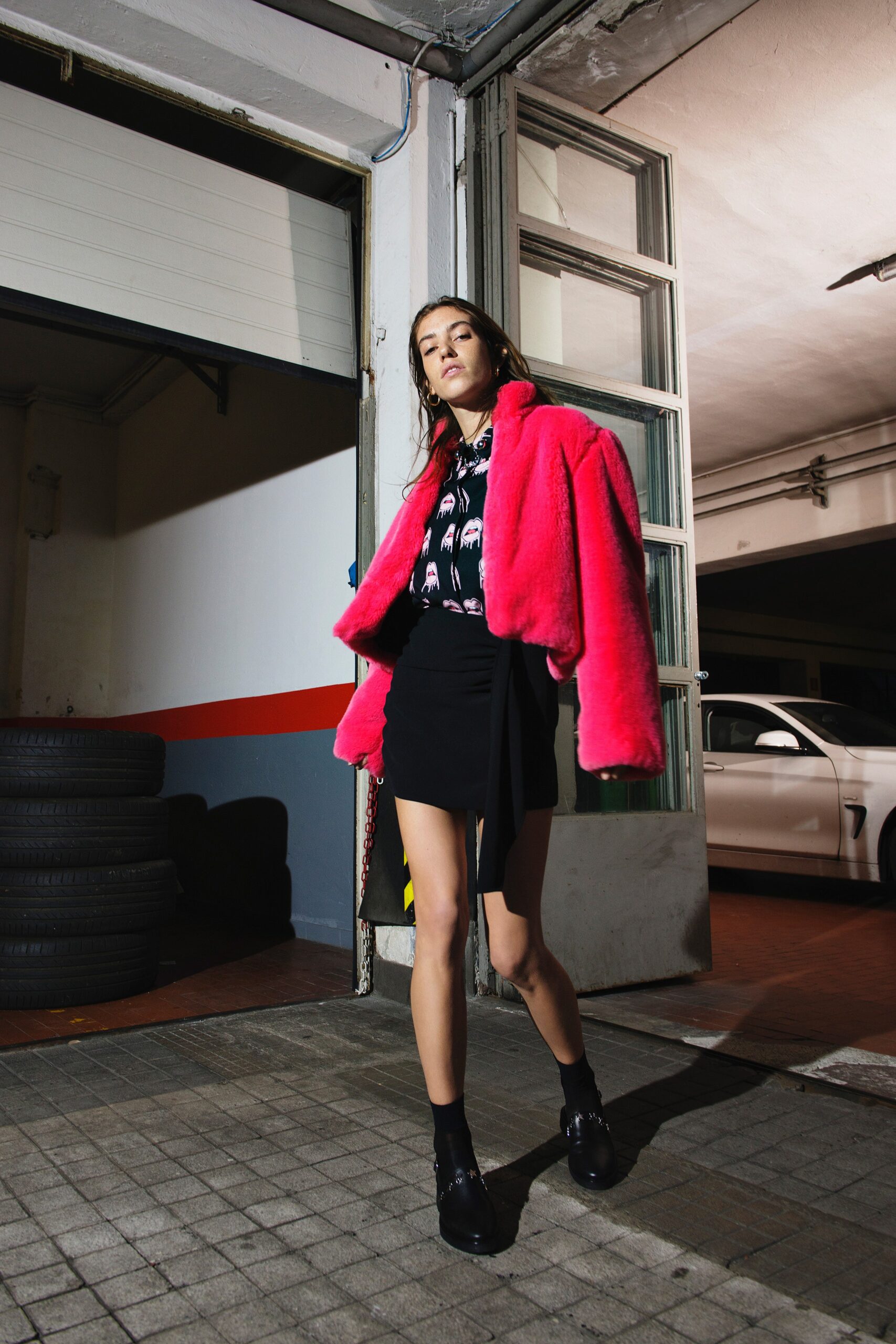 pink faux-fur coat with black mini skirt