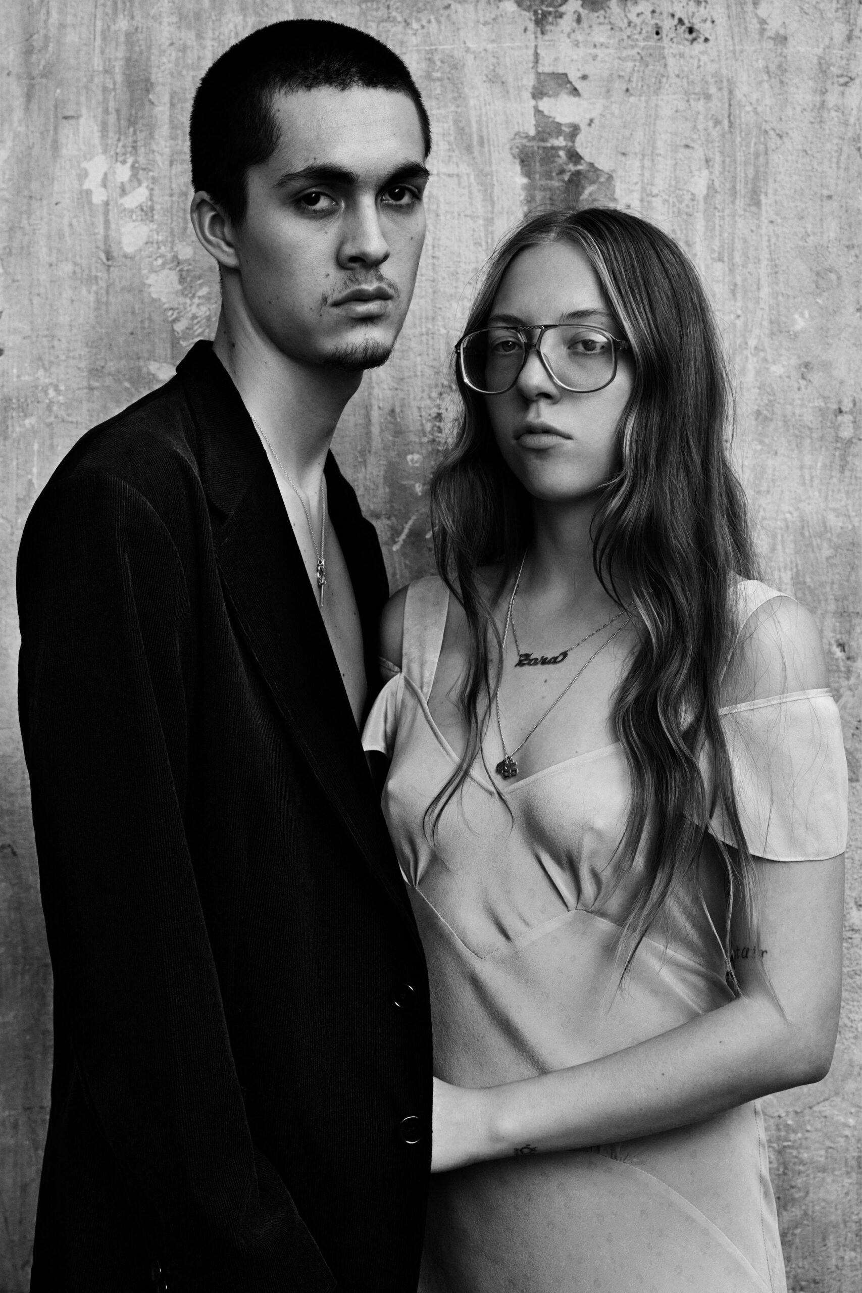 white silk fitted dress and black tailored blazer