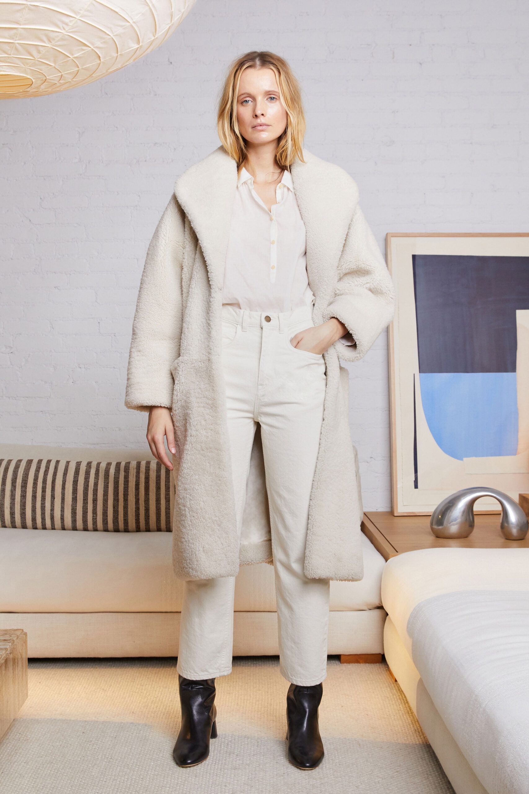 white faux-fur coat with beige pants
