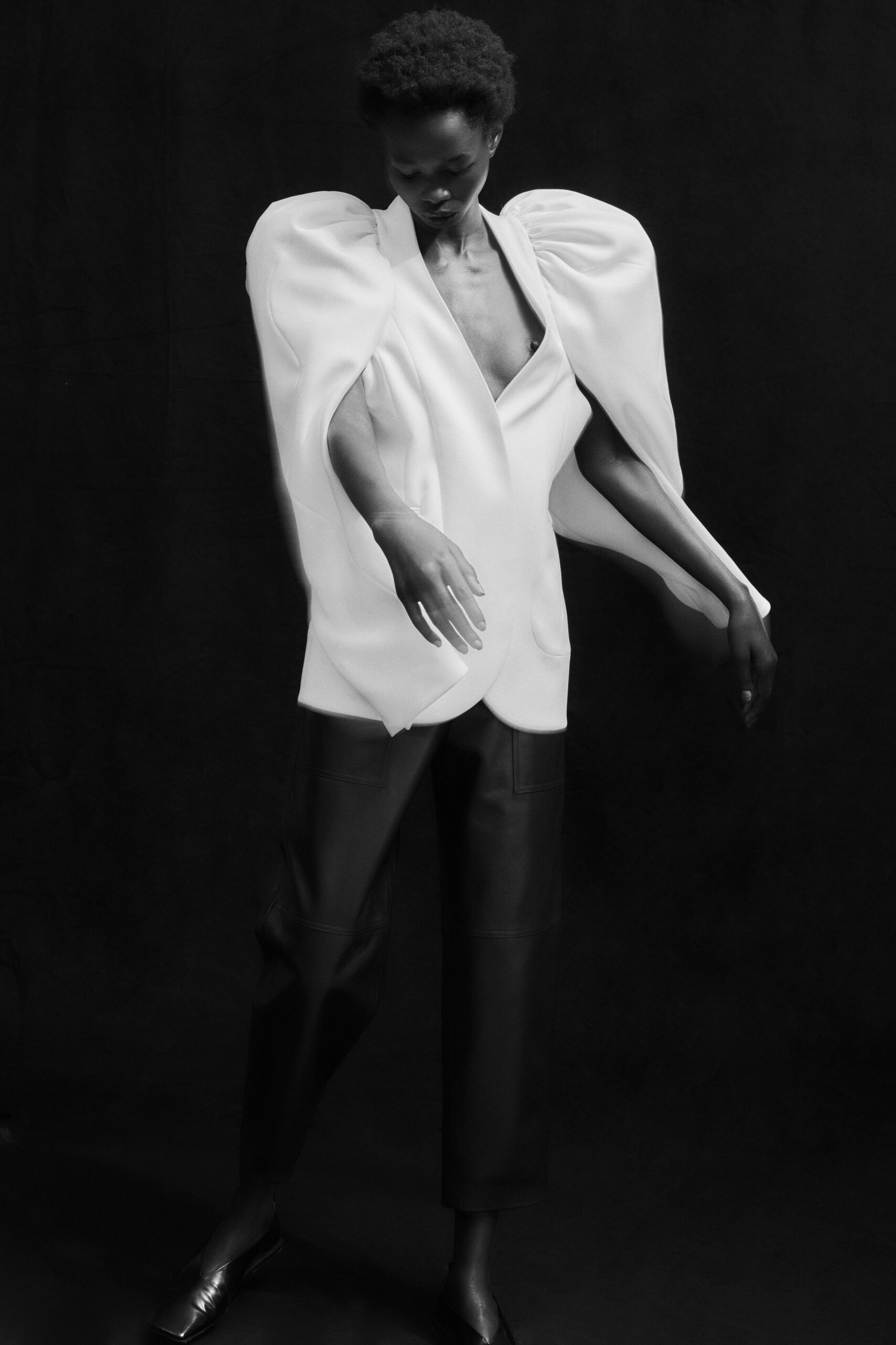 white draped blouse and black leather pants