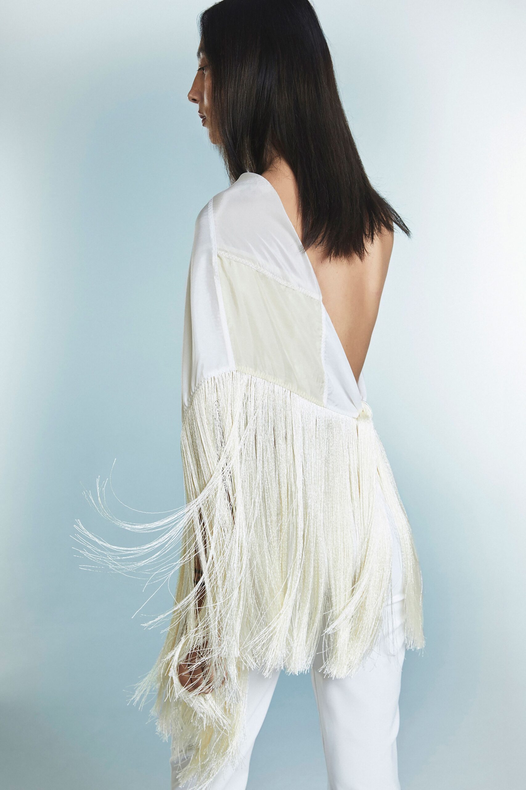 white silk fringed top with white pants