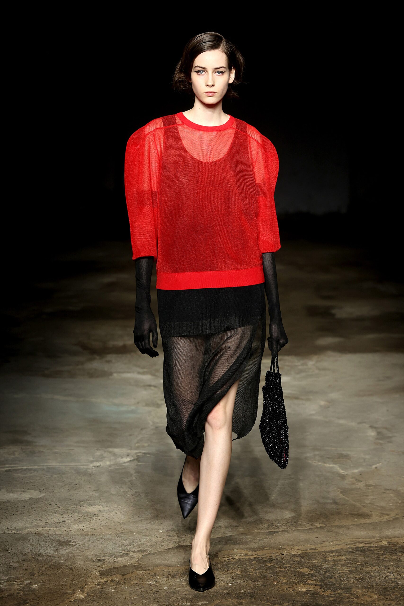 red sheer top with black skirt